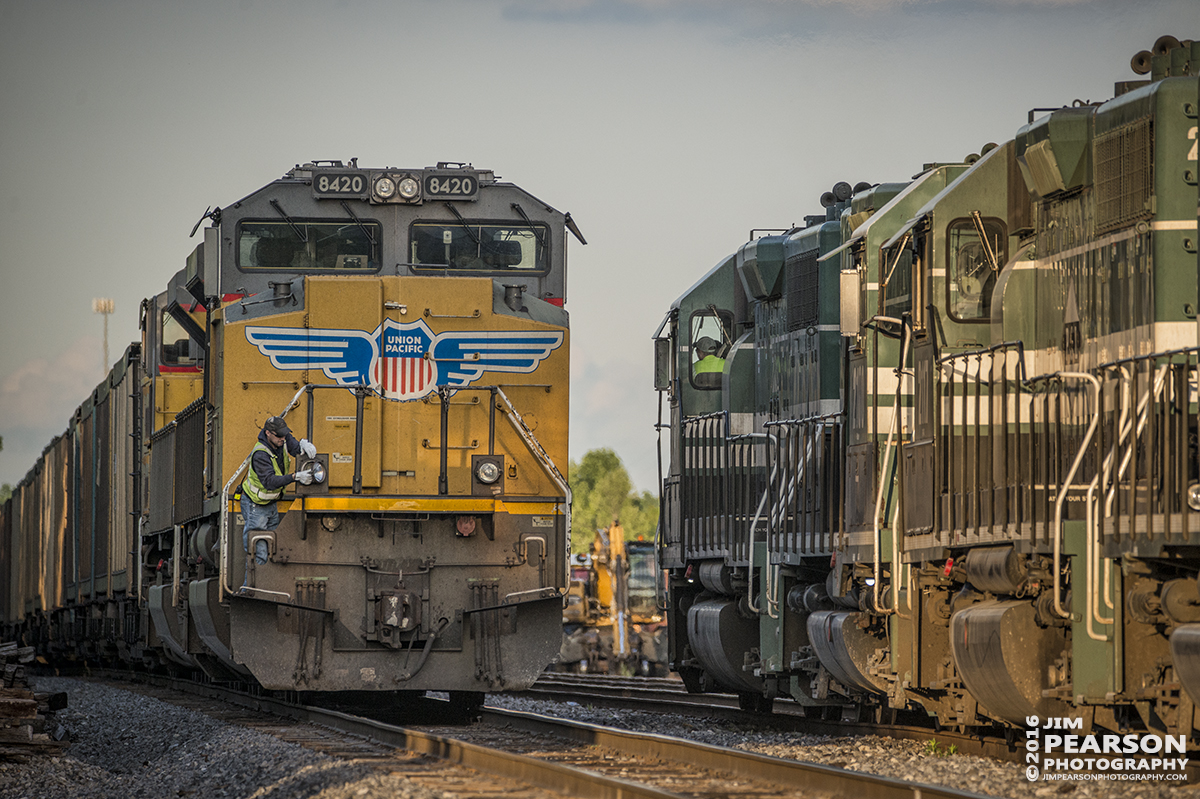 April 27, 2016 - At sunset a Paducah and Louisville Railway conductor changes a ditch light on UP 8420 as a northbound P&L local passes them at West Yard in Madisonville, Ky so they can move south with their loaded coke train to Calvert City, Ky. - Tech Info: 1/1000 | f/5.6 | ISO 800 | Lens: Sigma 150-600 @ 360mm on a Nikon D800 shot and processed in RAW.