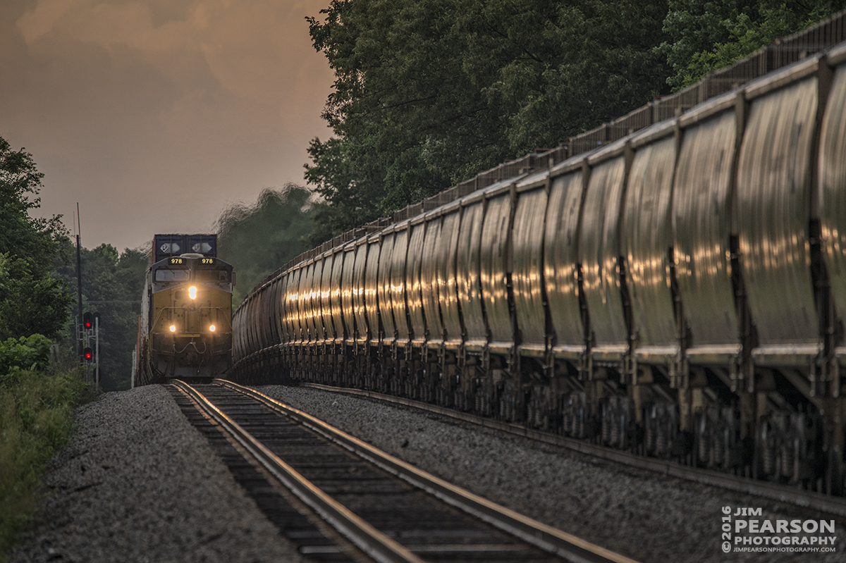 June 15, 2016  Lights reflect off wet hopper cars as southbound CSX Q029-15 crests the north end of Crofton, Ky passing CSX G127, a northbound empty grain train, after a storm front passed through the area on the Henderson Subdivision. - Tech Info: 1/500 | f/6.3 | ISO 800 | Lens: Sigma 150-600 @ 600mm with a Nikon D800 shot and processed in RAW.