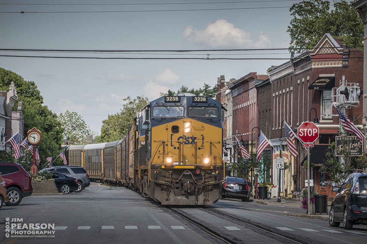 July 1, 2016  Autorack CSX Q241-30 (Detroit, MI- Louisville, KY) makes its way through downtown La Grange, Ky (one of the few places in the state that has street running) as it heads south to Louisville, Ky on the Short Line (LCL Subdivision). - Tech Info: 1/400 | f/20 | ISO 900 | Lens: Sigma 150-600 @ 165mm with a Nikon D800 shot and processed in RAW.