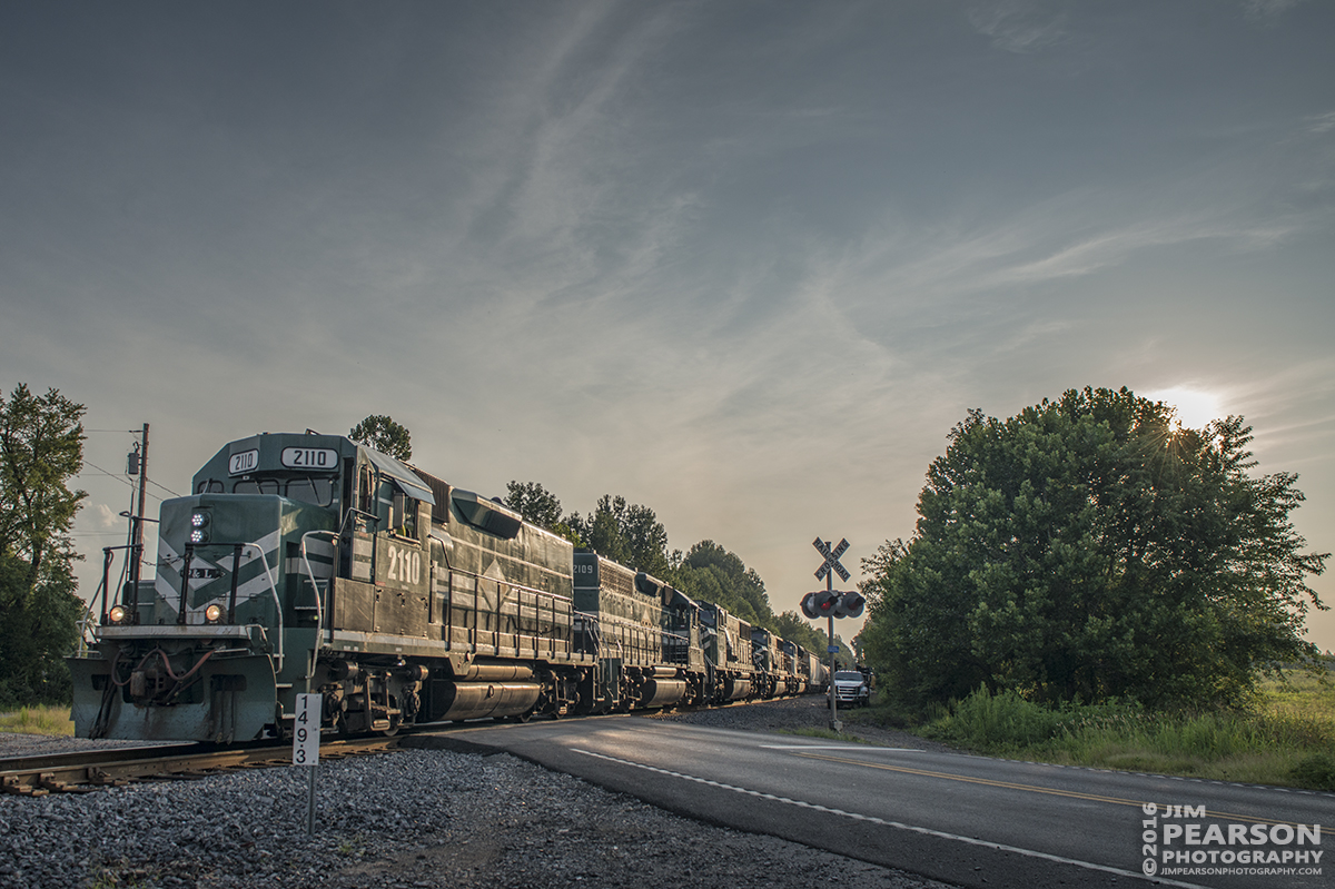 August 2, 2016  Paducah and Louisville Railway's engine 2110 leads a local train north through the crossing at West Yard in Madisonville, Ky as the sun starts to set as it makes heads for CSX's Atkinson Yard on the Henderson Subdivision for interchange work. - Tech Info: 1/1000 | f/6.3 | ISO 200 | Lens: Sigma 24-70 @ 24mm with a Nikon D800 shot and processed in RAW.