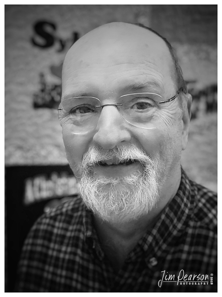 November 7, 2018 - Day 372 - iPhone 7 Plus Daily B/W Photo Challenge - Brad Downall - Today's portrait is of Brad Downall, the Executive Director of the Glema Mahr Center for the Arts here in Madisonville, Ky. A 1983 graduate in theatre from Hamline University in St. Paul, Minnesota, Brad worked in technical theatre in the Twin Cities and Duluth before moving to Madisonville, Kentucky in 1991 to serve as the first Technical Director at the Glema Mahr Center for the Arts at Madisonville Community College. Brad was promoted to Executive Director in 1999 and has focused on growing community-based activities such as the Summer Arts Academies and reviving community theatre while maintaining the quality of the presenting program and arts-in-education programs.  Brad is also a member of the Kentucky Presenters' Network and is on the Board of Directors for the Kentucky Theatre Association.