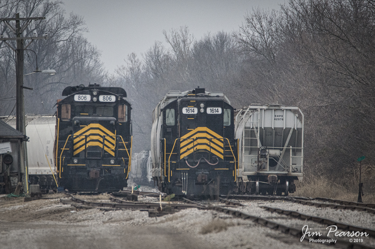 January 17, 2019 - Pioneer Lines PREX 806 and 1614 sit idle in the yard at the Indiana Southwestern Railway at their Harwood Yard in Evansville, Indiana. 

According to Wikipeda: Indiana Southwestern Railway (reporting mark ISW) is a subsidiary of Pioneer Railcorp, operator of several short-line railroad companies. The ISW is a Class III railroad, and operated on 17 miles of track from Evansville, Indiana, northward to Cynthiana, Indiana. That track is currently out of service but switching still occurs in ISWs yard and surrounding industries.

The line was originally operated as part of an Illinois Central Railroad line that ran all the way to Newton, Illinois. Illinois Central sold off the line south of Browns, Illinois, to Indiana Hi-Rail Corporation; the line went through a succession of operators, all of which had to contend with the lines ancient bridge over the Wabash River near Grayville, Illinois. The bridge suffered damage from floods on more than one occasion, and one span finally collapsed completely around 1999.

Pioneer bought the line and its Evansville shops in 2000 from the Evansville Terminal Railway. However, when Pioneer stopped shipping grain, the track had to be dismantled and salvaged at the close of 2011. Only the small stretch from the interchange northwest of Evansville to just north of their yard is still used, a distance of about 4 miles.

The dates back to 1881 as part of the Evansville and Peoria Railroad, which then became part of the Peoria, Decatur & Evansville Railway through a series of purchases. The PD&E became part of Illinois Central in 1900. The ISW is currently the only remaining in-service segment of the PD&E south of Mattoon, Illinois.