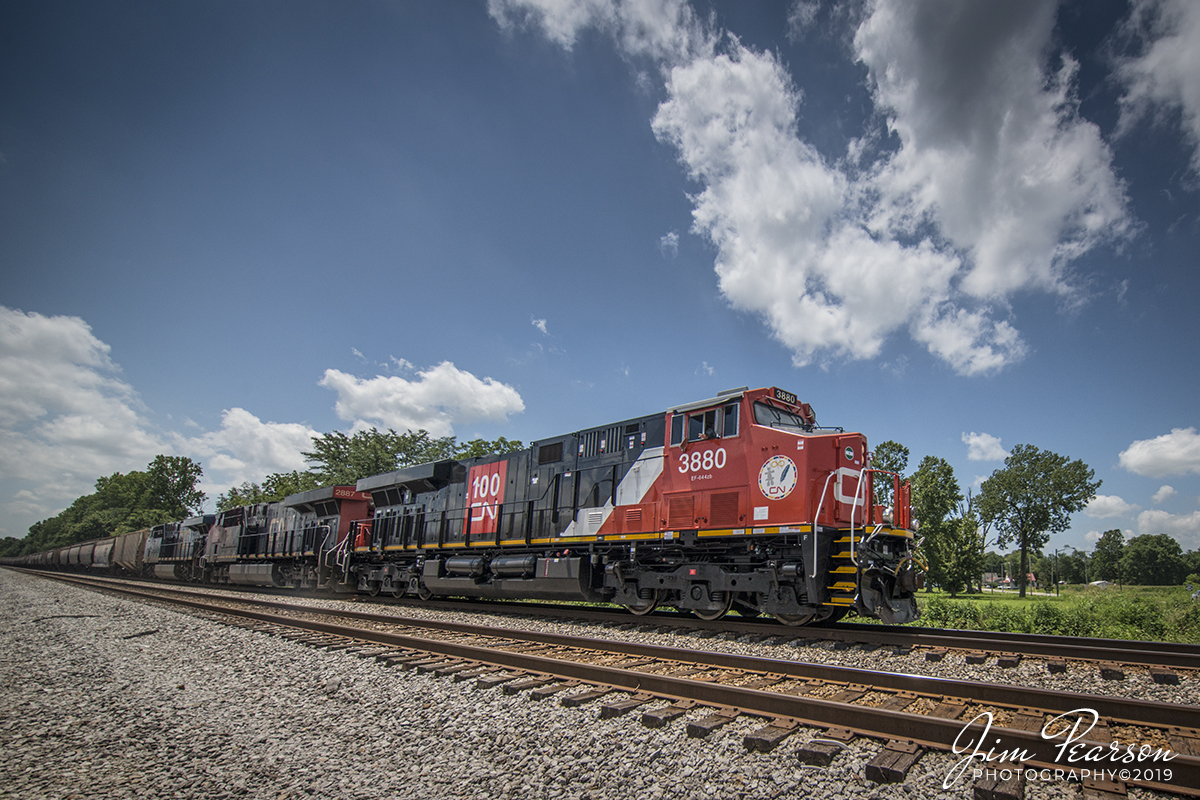 July 19, 2019 - Canadian National 3880 leads CSX empty grain train, V240-17 through Slaughters, Kentucky as it heads north on the Henderson Subdivision as the engineer Mr. Goldsberry gives a friendly wave.