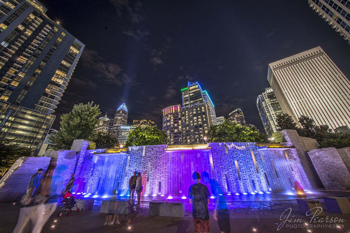 July 25, 2019 - Visitors of all ages love the interactive waterfall at Romare Bearden Park in Uptown Charlotte, North Carolina, even late at night!