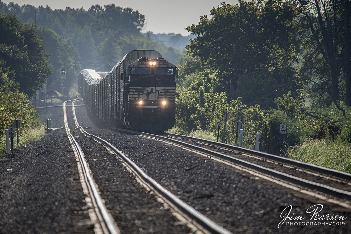 August 10, 2019 - Norfolk Southern empty autorack train 276 passes through the east end of Huntingburg, Indiana as it heads to Princeton, Indiana on the NS Southern-East District to drop off the empty cars for Toyota. Can't tell it from this shot, but the trailing unit is NS Unit 8101, Central of Georgia heritage unit.