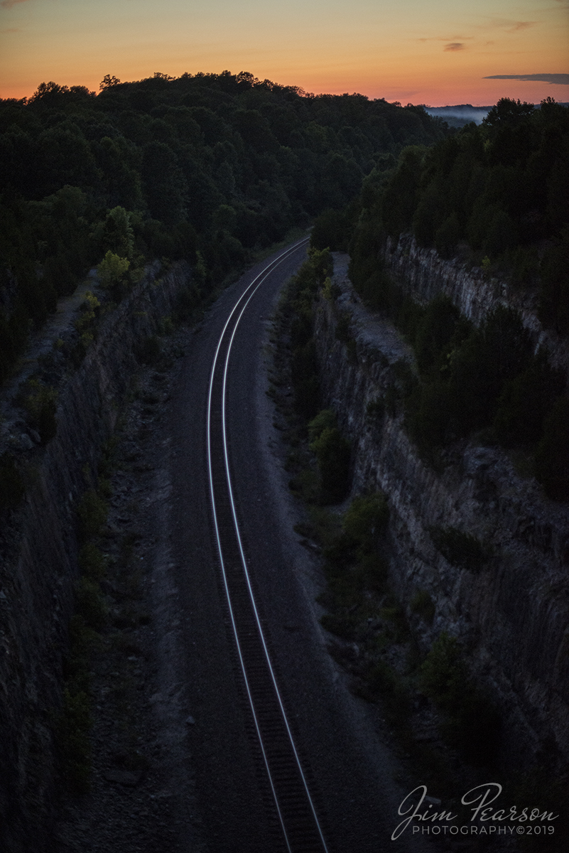 August 10, 2019 - The last light of day illuminates the rails that cut through Tunnel Hill at Depauw, Indiana on the NS Southern-East District.
