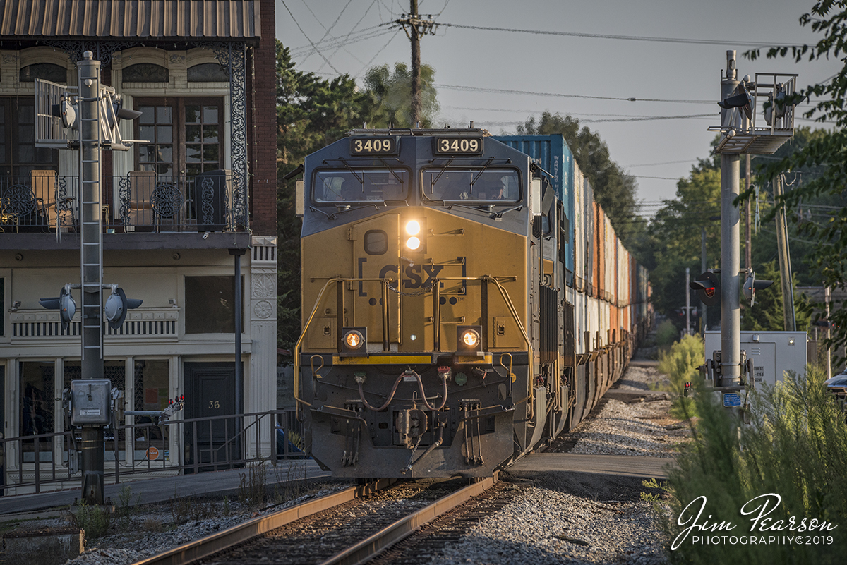 August 19, 2019 - CSX intermodal Q026-18 passes through the crossing at West Center Street in Madisonville, Kentucky on the Henderson Subdivision with CSXT 3409 leading the way.