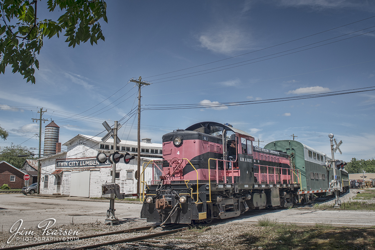 August 24, 2019 - Indiana Railroad Museum's #4 (Ex Algers, Winslow and Western Railway #4, Built as Duluth, South Shore and Atlantic #103) heads through the crossing at Twin City Lumber Company as it pulls a passenger train south on the French Lick Scenic Railway from French Lick, Indiana. 

According to their website: The Indiana Railway Museum is a tourist railway located in French Lick, Indiana. The Museum was founded in 1961 in the town of Westport, Indiana where the railroad operated a tourist excursion, utilizing one small locomotive, three passenger cars, and about twenty volunteers. Ridership was estimated at about 500 passengers in 1962. 

The museum and railway remained in Westport until a move was necessitated in 1971. The organization relocated to Greensburg, Indiana where it operated until 1976 when it again, it changed locations. The Museum was relocated to French Lick in 1978 after an agreement with the Southern Railway Company. 

They deeded the Museum a total of sixteen miles of track stretching from West Baden, Indiana, approximately one mile north of French Lick, to a small village named Dubois, to the south.

The Indiana Railway Museum currently operates as The French Lick Scenic Railway operating passenger trains over twenty-five miles of this track from French Lick to Jasper. 

Visit them at: http://rhpfrench18.wpengine.com/