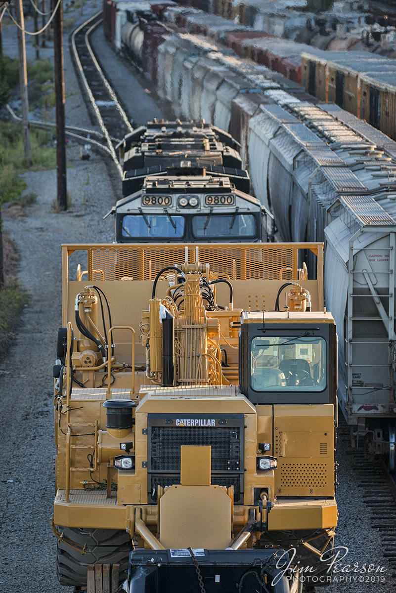 September 21, 2019 - A NS mixed freight slowly makes its way through DeButts Yard at Chattanooga, Tennessee with a Caterpillar Earth Mover High and Wide Load on its way south on the CNO&TP Third District.