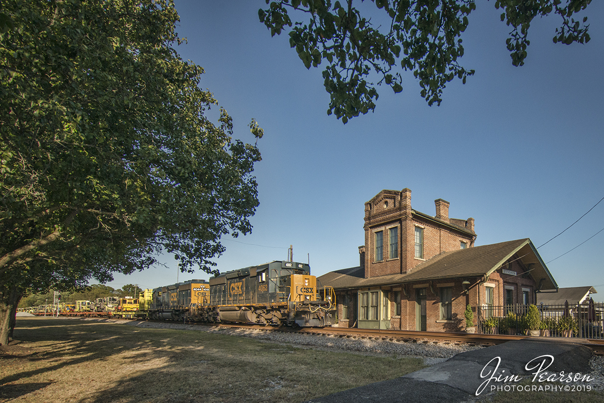 September 22, 2019 - CSX W032-17, with CSXT 4062 a SD40-3 leading, passes the depot at Stevenson, Alabama as it heads north on the Chattanooga Subdivision with a load of MOW equipment.

According to Wikipedia: The Stevenson Railroad Depot and Hotel are a historic train station and hotel in Stevenson, Alabama. They were built circa 1872 as a joint project of the Memphis and Charleston Railroad and the Nashville and Chattanooga Railroad, whose lines converged in Stevenson. When the Memphis & Charleston was purchased by the Southern Railway in 1898, the Louisville and Nashville Railroad (who had taken over the N&C in 1880) took sole control of the depot and operated it until 1976. 

It was converted into a history museum in 1982. Both buildings are brick with gable roofs and Italianate details. The depot has a central, second-story tower that was added in 1887. The three-story hotel had a lobby, dining room, and kitchen on the first floor and eight large guest rooms on the upper floors. The buildings were listed on the Alabama Register of Landmarks and Heritage in 1975 and the National Register of Historic Places in 1976.

The building is now operated as the Stevenson Railroad Depot Museum and features area railroad and Civil War artifacts
