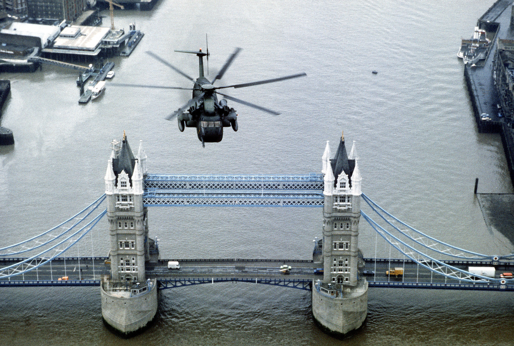 December 10, 1982 - A front view of an HH-53 Super Jolly helicopter in flight over the Tower Bridge in London, England during a US Air Force pararescue training exercise. The helicopter was assigned to the 67th Aerospace Rescue and Recovery Squadron. - USAF Photo by SSgt. James R. Pearson