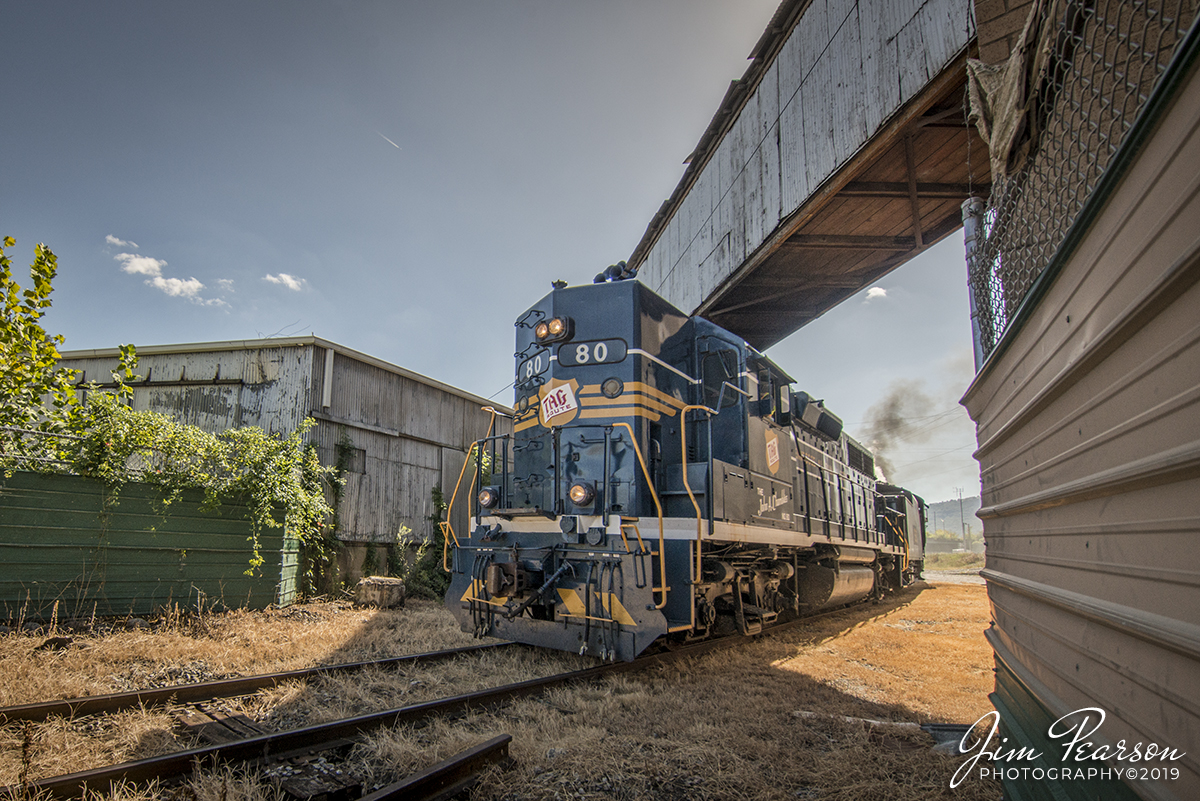 September 21, 2019 - The John A. Chambliss "TAG 80" passes through and industrial section of Chattanooga, Tennessee, as it returns from a photo charter run to Chickamauga, Georgian, with Southern 4501, all dressed up as L&N 1593 trailing, during the L&N Historical Society weekend at the Tennessee Valley Railroad Museum (TVRM).

According to the TVRM Website it was built for the Tennessee, Alabama & Georgia Railway in 1968, TAG 80 was the last and most powerful engine purchased by that railroad. The engine was named "The John A. Chambliss" in honor of the railroad's vice president, and dedicated on his 80th birthday. 

The 80 was later sold to the Southern Railway, and later became the property of Norfolk Southern, who sold it at auction to the Chambliss family in 2001, who then donated the locomotive to TVRM. The locomotive was restored mechanically, electrically and cosmetically between 2015 and 2016, returning to service in March 2017. It is a model GP38, developing 2,000 horsepower.