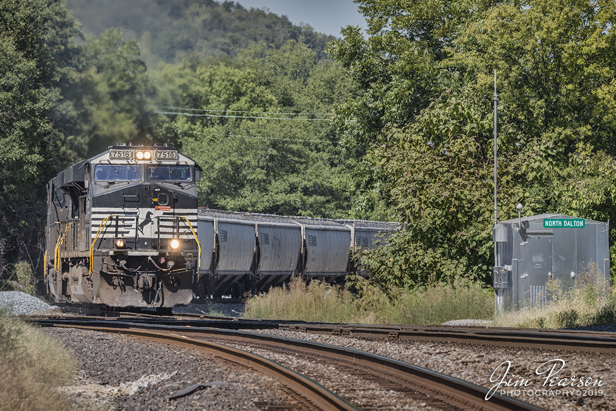 September 22, 2019 - A Norfolk Southern loaded grain train prepares to pass through the NS/CSX Diamond in downtown Dalton, Georgia as it heads south on the NS Georgia Division.

According to the website http://railfanlocations.weebly.com/ Downtown Dalton, Georgia is a railfan hotspot with 40 to 45 trains in an average day. Dalton is one of the few (if not only) places in Georgia where the CSX and Norfolk Southern Railway cross each other at grade. Norfolk Southern sold the former Southern Railway freight depot to the City of Dalton. The city has restored the old freight station and created an excellent train watching location, as well as a visitor’s center.
