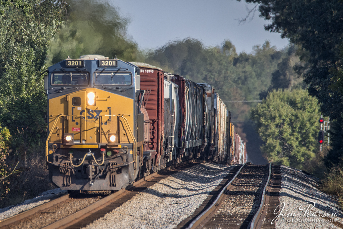 September 28, 2019 - CSXT 3201 leads Q503-27 as it crests the hill at the north end of Crofton Siding as it heads south on the Henderson Subdivision at Crofton, Ky in the early morning light.