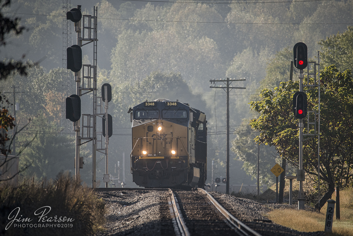October 8, 2019 - With just a hint of fall color in the background, empty coal train CSX E319 glides onto the Earlington Cutoff at Mortons Junction in Mortons Gap, Kentucky as it heads north on the Henderson Subdivision.