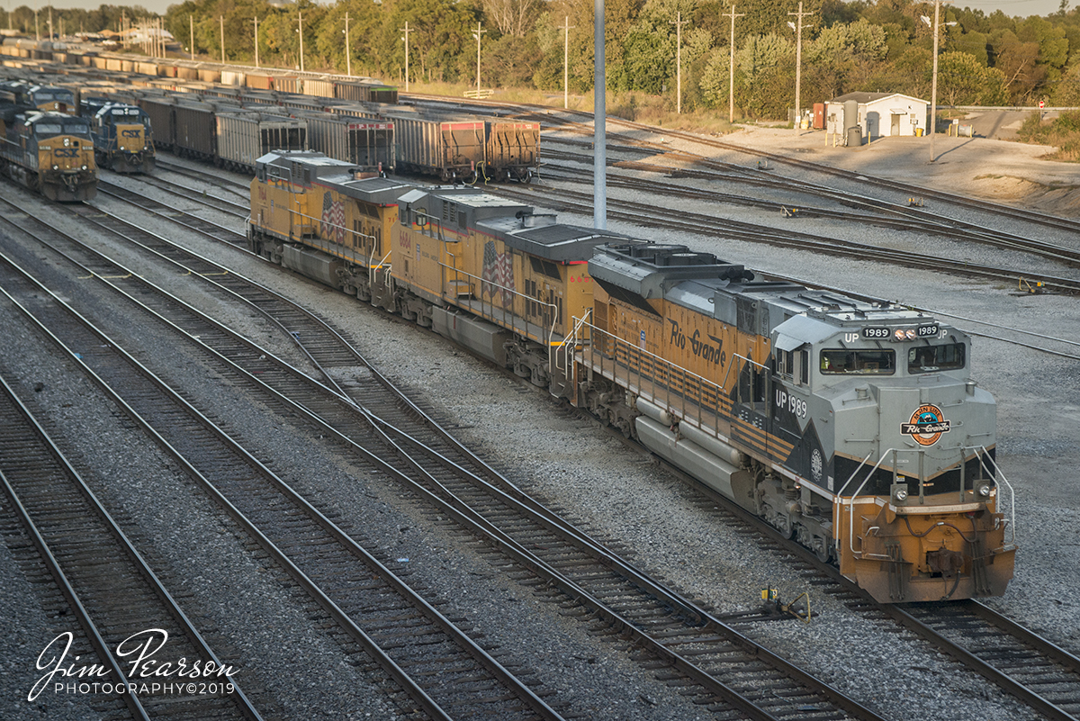 October 14, 2019 - Union Pacific 1989, Denver Rio Grand Heritage Unit, pulls past a switch at CSX's Howell Yard in Evansville, Indiana, after dropping off a trailing CSXT unit from it's consist. It is leading a southbound loaded coke train CSX W221-13 on it's way down the CE&D, Henderson and other Subdivisions in Illinois, Indiana, and Tennessee on its way to Georgia. It's trailing units here are UP 6684 and 7164.

According to Wikipedia: Union Pacific 1989: Serial number 20056723-098, is painted in Denver and Rio Grande Western Railroad colors. It was delivered on 24 May 2006, unveiled on June 17, 2006, at a special UP employee event in Denver, Colorado.

It is one of six EMD SD70ACe locomotives that are painted in the liveries of railroads acquired by the Union Pacific. The company says the locomotives "pay homage to those railroads and the generations of men and women who helped to build a great nation and the foundation for our future."