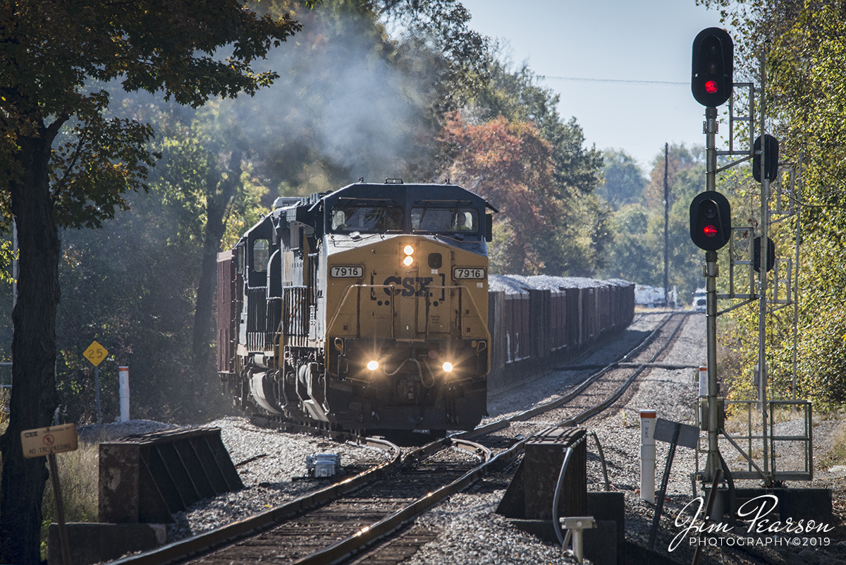 October 23, 2019 - CSXT 7916 leads loaded ballast train W089 as it pulls onto the Henderson Subdivision main from the siding at the north end of Latham in Hopkinsville, Kentucky as it continues its trip north.