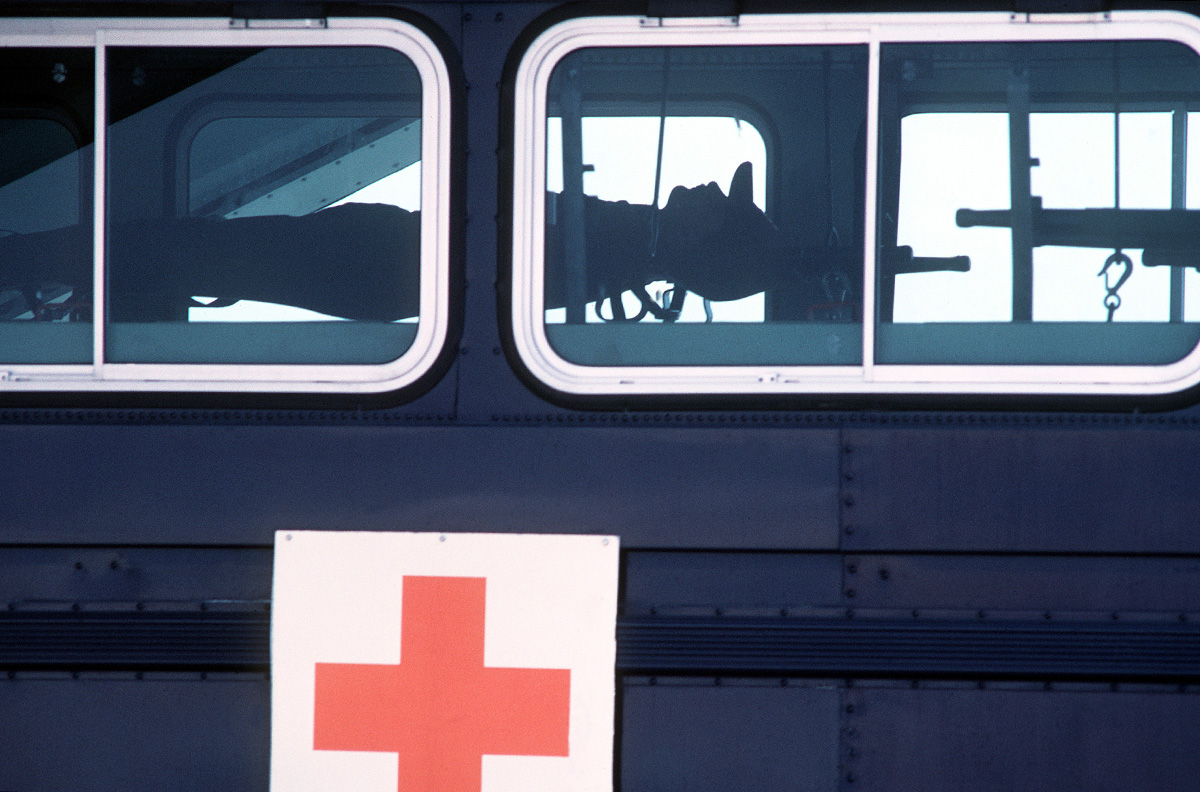 Blast From The Past - January 1982 - A simulated casualty waits to be transferred from a medical bus to a C-141B Starlifter aircraft during Exercise Wounded Eagle '82 at Norton AFB, California. - USAF Photo by SSgt. James R. Pearson
