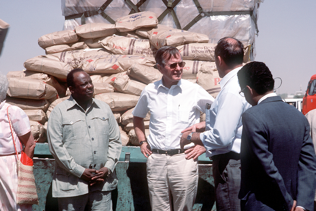 Blast From The Past - March 6, 1985 - Vice-President George Bush, who was in the Sudan on a fact finding tour, receives a briefing on the U.S. Ethiopian relief operation from Dr. Philip Johnston, executive director of CARE.  Over 50,000 pounds of food and supplies were delivered to the airport aboard a 6th Military Airlift Squadron aircraft. - USAF Photo by James R. Pearson
