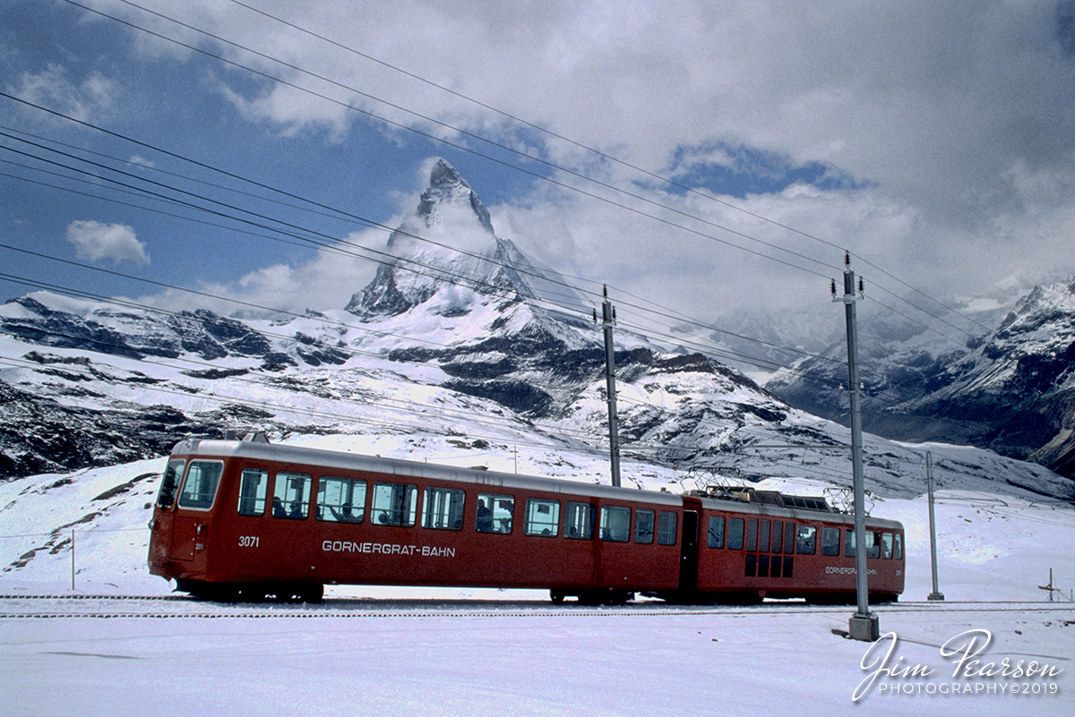 Blast From The Past - 1994 - Today's photo serves a dual purpose. It's a photo taken during my military days, but is also my daily train photo. This is a mountain rack railway called the Gornergrat-Bahn as it heads up to Gornergrat from Zermatt, Switzerland, passing the Matterhorn in the background. 

It was taken during "Operation Deny Flight" which was a North Atlantic Treaty Organization (NATO) operation that began on 12 April 1993 as the enforcement of a United Nations (UN) no-fly zone over Bosnia and Herzegovina. 

The United Nations and NATO later expanded the mission of the operation to include providing close air support for UN troops in Bosnia and carrying out coercive air strikes against targets in Bosnia. Twelve NATO members contributed forces to the operation and, by its end on 20 December 1995, NATO pilots had flown 100,420 sorties.

For 6-months of this operation I was the photo editor for a Combat Camera team that worked out of Aviano, Italy covering the operations. On the weekends, our schedules allowed us some time to travel and on one three day weekend I took the train from Italy to Switzerland and made this photo, along with many other images.

According to Wikipedia: The Gornergrat Railway (German: Gornergrat Bahn; GGB) is a mountain rack railway, located in the Swiss canton of Valais. It links the resort village of Zermatt, situated at 1,604 m (5,262 ft) above mean sea level, to the summit of the Gornergrat. The Gornergrat railway station is situated at an altitude of 3,089 m (10,135 ft), which makes the Gornergrat Railway the second highest railway in Europe after the Jungfrau, and the highest open-air railway of the continent. The line opened in 1898, and was the first electric rack railway to be built in Switzerland.

The Gornergrat is a starting point for many hikes, as it lies surrounded by 29 peaks rising above 4,000 m (13,123 ft) in the Alps and several glaciers, including the Gorner Glacier (which is billed as the second longest glacier in the Alps). At the end of the line on Gornergrat, the Matterhorn is visible on a clear day. It is also a popular skiing area.

Work on the railway started in 1896, five years after the Visp-Zermatt-Bahn had linked Zermatt to Visp and the Rhone Valley. The line opened on August 20, 1898, and was electrified from the start. Initially it only operated in summer, but year-round operation was extended to the lower section of the line in 1929, and to the summit in 1941.