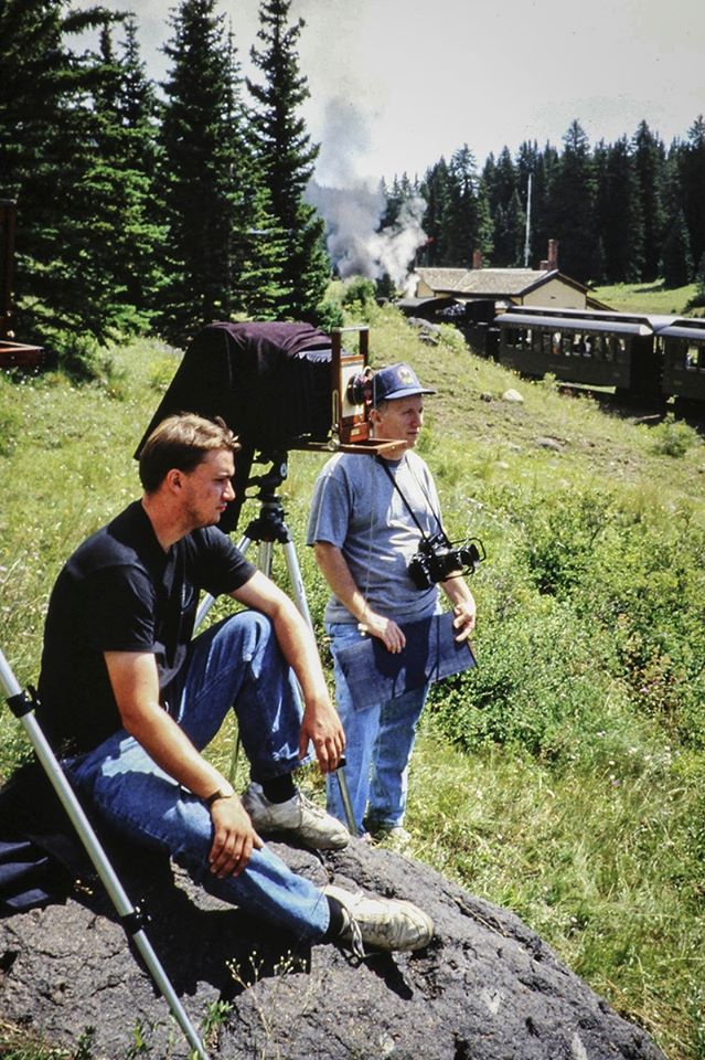 Blast From The Past - Summer, 1999 - Those were the days! Here I'm working on shooting on the Cumbres and Toltec Scenic Railway with my 8X20" panoramic view camera somewhere around Chama, New Mexico with my godson Dale Grant. He, his dad Norm and good friend Jose Lopez Jr. all met up at Chama for a weekend of chasing the trains.

It was an interesting camera and one of several pan cameras I've owned over the years during the film days. The only one I still have left is a 4x10" Alt View, built by Patrick Alt in Los Angeles, California at the time. Now with the scarcity of film and processing chemicals it too may go up for sale here before long. Now it's just a nice display piece as I no longer even have a darkroom setup here at home.

I was, like many, was brought up in the film age of photography and I attribute my "seeing" to what I learned over the years of shooting film and having to know what my photo was going to look like as I shot it without looking at it right afterwards, as we do today with digital.

I have to admit we have come a long way from film since the first digital cameras I used in the Air Force back in the late 1970s. In some ways it's much better and in others not so much, but either way, shooting film I feel has made me "see" pictures better when I'm out shooting digital today.