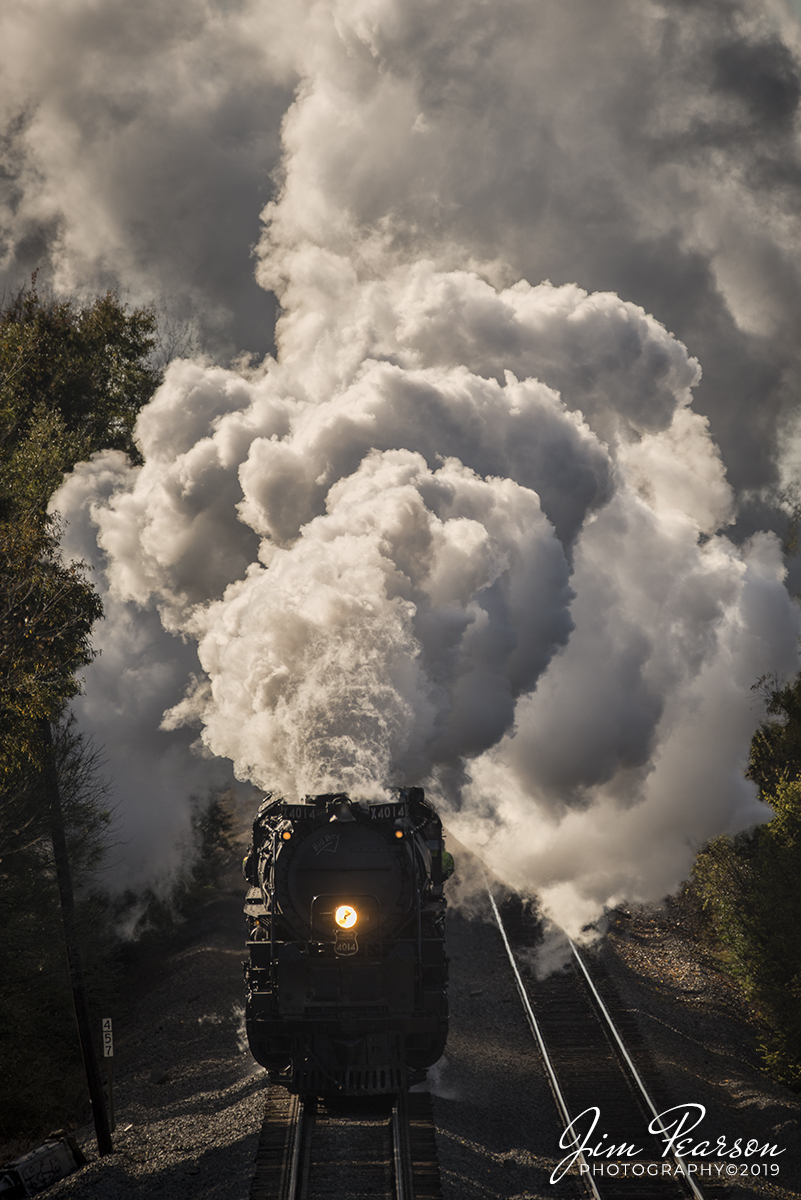 November 12, 2019 - Union Pacific's "Big Boy" 4014 puts out a huge plume of steam in the cold November air as it departs Hope, Arkansas and heads north on the UP Little Rock Subdivision on its way to Prescott, AR where it will tie down for the night. I'm doing my first chase on the "Big Boy" today and tomorrow as it heads for Little Rock, AR.

According to Wikipedia: The Union Pacific Big Boy is a type of simple articulated 4-8-8-4 steam locomotive manufactured by the American Locomotive Company between 1941 and 1944 and operated by the Union Pacific Railroad in revenue service until 1959.

The 25 Big Boy locomotives were built to haul freight over the Wasatch mountains between Ogden, Utah, and Green River, Wyoming. In the late 1940s, they were reassigned to Cheyenne, Wyoming, where they hauled freight over Sherman Hill to Laramie, Wyoming. They were the only locomotives to use a 4-8-8-4 wheel arrangement: four-wheel leading truck for stability entering curves, two sets of eight driving wheels and a four-wheel trailing truck to support the large firebox.

Eight Big Boys survive, most on static display at museums across the country. This one, No. 4014, was re-acquired by Union Pacific and restored to operating condition in 2019, regaining the title as the largest and most powerful operating steam locomotive in the world.