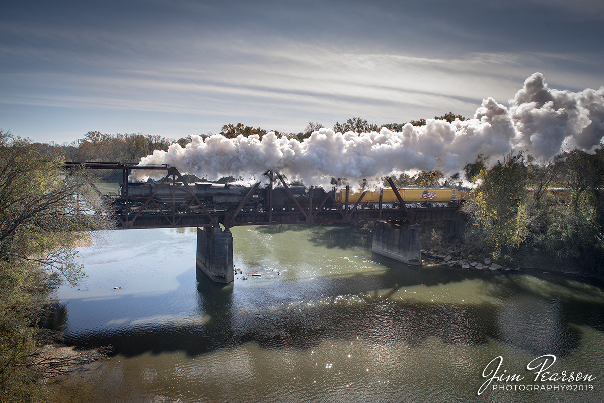 November 13, 2019 - Union Pacific 4014 Big Boy heads across the Ouachita River at Arkadelphia, Arkansas as it races north on the Little Rock Subdivision with it's passenger train on UP's Race Across the Southwest event. 

Did you know: Union Pacific placed two orders for Big Boys. In 1941, they ordered 20. In 1944, five more were constructed. Their territory was basically the 435 miles between Cheyenne, Wyoming and Ogden, Utah. As a class, Big Boys ran until 1959, with some coming out of service earlier. Additionally, from 1941 to 1948, Big Boys only worked the 163 miles from Ogden to Green River, Wyoming. 

From 1948 to 1959, they did not travel west of Green River. In their final years, the Big Boys only worked the 58 miles between Cheyenne and Laramie, Wyoming. Every one of the first 20 Big Boys tallied over one million miles of service. The last five had all traveled over 800,000 miles when they were retired. All this on a piece of railroad just over 400 miles long. For the record, #4017 traveled 1,052,072 miles during its life.