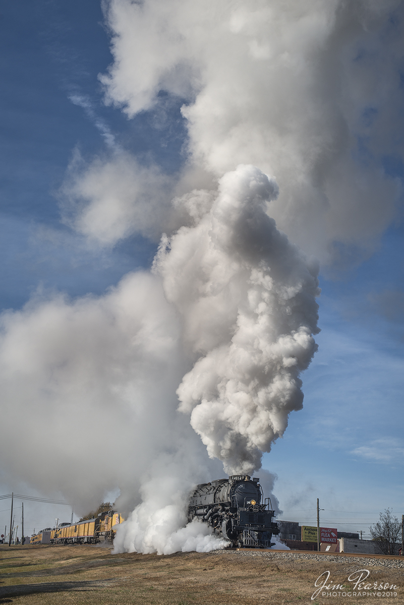 November 13, 2019 - Union Pacific's Race Across the Southwest was on the move again as UP 4014 Big Boy departs Prescott, Arkansas on its way north on the UP Little Rock Subdivision on a beautiful and cold fall morning. As you can tell the cold weather went a long way in producing beautiful plumes of steam!! 

Did you know: The Big Boy and its tender is only 100 feet shorter than a Boeing 747! It takes a sedan, a school bus, and a diesel engine to match the length of the Big Boy and its tender. With a height of 16 feet 4 inches, and a length of 132 feet, it falls short of the 232 foot Boeing 747 only by 100 feet!