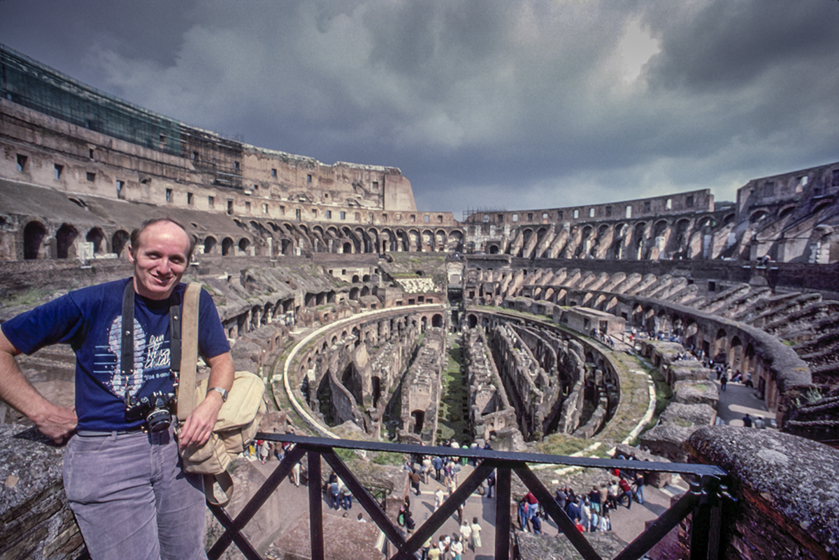 Blast From The Past - Summer 1980 - Today's photograph is of me standing in the Coliseum in Rome, Italy. The Colosseum's original Latin name was Amphitheatrum Flavium, often anglicized as Flavian Amphitheatre. The building was constructed by emperors of the Flavian dynasty, following the reign of Nero. This name is still used in modern English, but generally the structure is better known as the Colosseum.

I visited Rome on several occasions through-out my career as a photojournalist working for Combat Camera (Aerospace Audiovisual Service at this time) and have been truly blessed with the ability to travel the world. At last count I think I've visited 67 different countries on photo assignments or vacation to shoot pictures! 

This shot was taken sometime in 1980 and I'm thinking it was sometime in early summer if I recall correctly. At the time I was stationed at Rhein Main Air Base just outside of Frankfurt Germany. I lived in a little village called Morefelden and it was a great assignment! 

I used to drive what was called a VW Limousine, which was much more boxy than a standard VW Beetle. However, my favorite mode of transportation, especially for going to downtown Frankfurt, West Germany was by train! Sometimes I would take the one right out of town, but when I did I'd have to go through and change trains at the Frankfurt International Airport. I'd also drive to the station at Zeppelinheim and leave the car there. It was a more direct route. 

It was also the home of the Zeppelin Museum Zeppelinheim near Frankfurt am Main (On the Main River). The design of the museum building, constructed in 1988, resembles a quarter section of the hull of the LZ 10. The transport airships Graf Zeppelin and Hindenburg, as well as the second Graf Zeppelin (LZ 130), were based near the present site of the museum, on a site later occupied by the Rhein-Main Air Base.