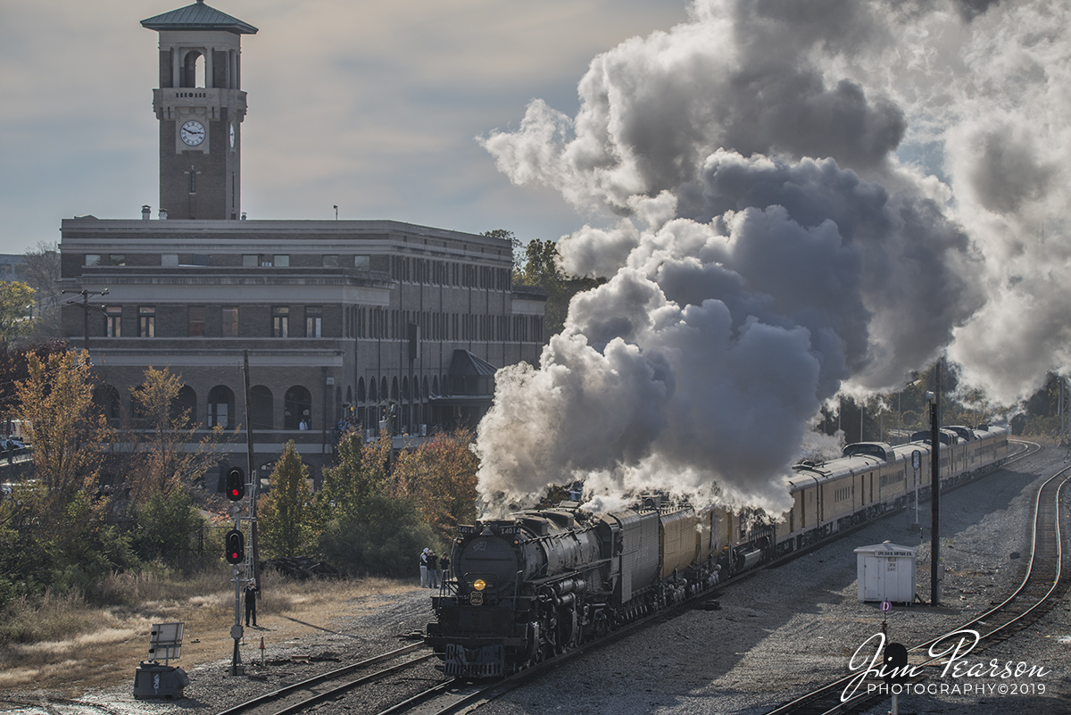 November 13, 2019 - Union Pacific 4014 Big Boy pulls it's train north out of Union Station at Little Rock, Arkansas on a cold fall afternoon. 

Union Pacific billed this move as The Great Race Across the Southwest as the train is making a circle around the southwest over a six week or so period hitting Arkansas, Arizona, California, Colorado, Kansas, Missouri, Nevada, New Mexico, Oklahoma, Texas, Utah and Wyoming.

According to Wikipedia: Little Rock Union Station, also known as Mopac Station, is a train station in Little Rock, Arkansas, United States served by Amtrak, the national railroad passenger system.

The present Little Rock station opened August 1, 1921, having been constructed by the Missouri Pacific Railroad after a fire destroyed the prior station on April 7, 1920. The structure used existing foundations, some exterior walls and the clock tower of the previous station, which had survived the fire. The station is listed on the National Register of Historic Places as "Mopac Station".

Although known as Union Station, this particular structure was used by only a single railroad, Missouri Pacific. Prior structures on this site were served by two additional railroads, Memphis & Little Rock (18741893) and St. Louis Southwestern Railroad (known as the 'Cotton Belt'). (ca. 18921910). The present (1921) structure was predated by a large wooden structure erected in 1874, and a brick station that opened in 1909 and burned in 1920.

The main entrance to Union Station was located on the Markham Street level, and waiting rooms, ticket office and a restaurant were located on this level. The upper two floors housed the railroad's train dispatchers and offices of the freight and passenger departments, American Refrigerator Transit, and the Pullman Company, which staffed the sleeping and dining cars of passenger trains. The basement (track level) held extensive mail and Railway Express Agency facilities, a baggage room, and a small dining car commissary. Passenger access to the tracks was via an open air midway extending from the north side of the building, with stairways and three umbrella sheds extending in each direction at track level. This midway structure was original to the 1908 station, having survived the 1920 fire.

Missouri Pacific passenger service to Little Rock ended just after midnight on May 1, 1971. The remaining umbrella sheds and midway were dismantled in October 1973, less than six months before Amtrak began a new passenger route through Little Rock. Amtrak continued to use the original waiting room and ticket office area until July 1992. The waiting area and ticket offices were relocated to a newly renovated area of the station located at track level.