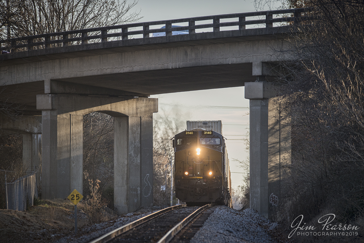 November 27, 2019 - CSXT 3140 leads intermodal Q026 as it crests the rise under the North Main Street overpass at Madisonville, Kentucky as it heads north on the Henderson Subdivision.