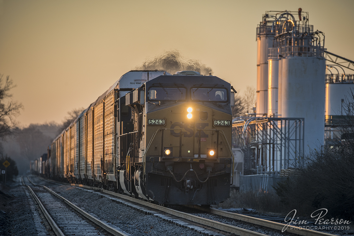 December 7, 2019 - CSX Q506-07 races the early morning sun as it passes the Deltech Polymers Corporation plant at Troy, Ohio as it heads north on the Toledo Subdivision. 

According to Wikipedia: The Toledo Subdivision is a railroad line owned and operated by CSX Transportation in the U.S. state of Ohio. The line runs from Hamilton (north of Cincinnati) north to Perrysburg (near Toledo) along a former Baltimore and Ohio Railroad line.

The south end of the Toledo Subdivision is at the end of the Cincinnati Terminal Subdivision, near the east end of the Indianapolis Subdivision. Its north end is at the end of the Toledo Terminal Subdivision. In between, it junctions with the Middletown Subdivision at New Miami, the Indianapolis Line Subdivision at Sidney, and the Garrett Subdivision at Deshler.

South of Dayton, the Toledo Subdivision was opened by the Cincinnati, Hamilton and Dayton Railroad in 1851. Later that decade in 1858, the Dayton and Michigan Railroad opened, continuing the line to Toledo. The lines passed to the Baltimore and Ohio Railroad and CSX through leases and mergers.