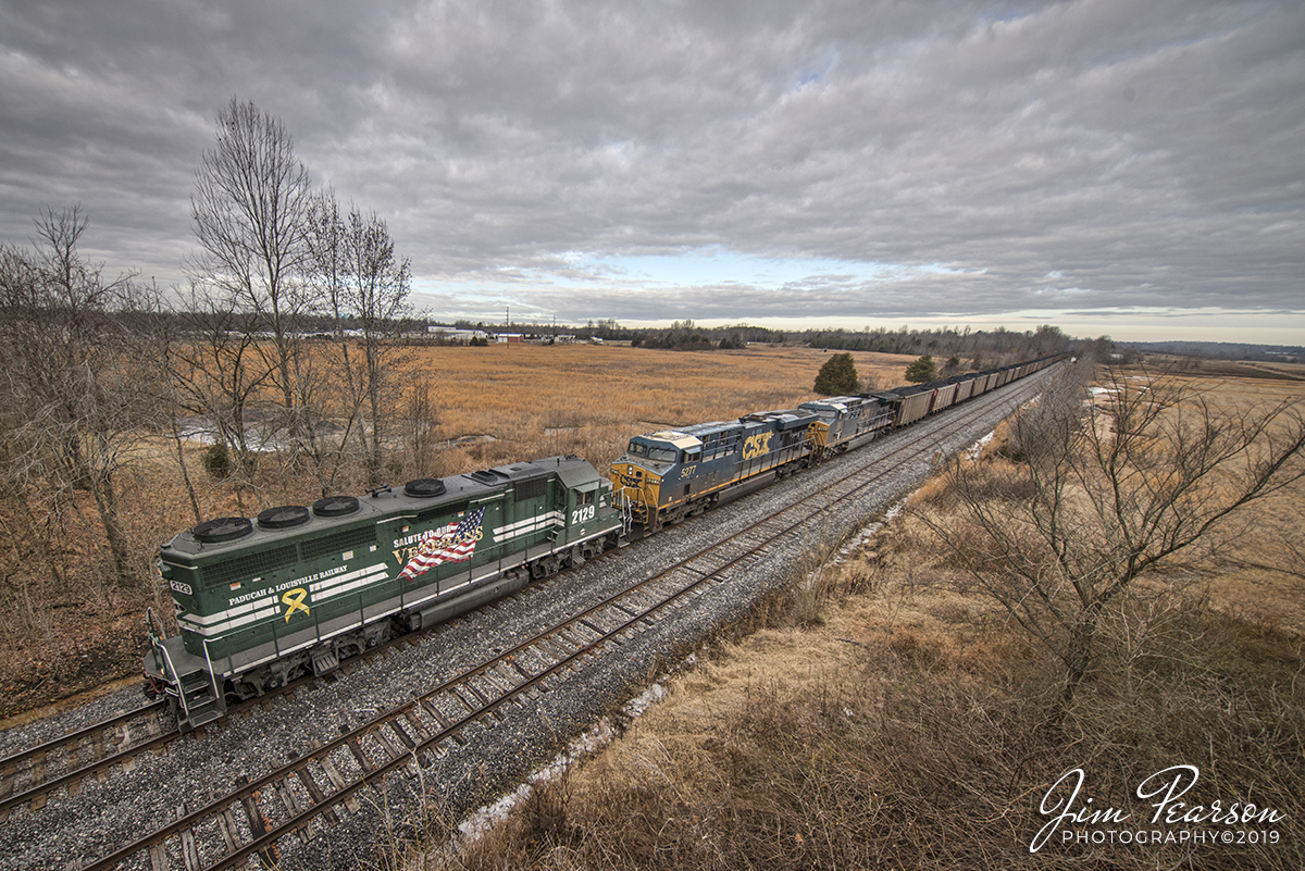 December 21, 2019 - Paducah and Louisville Railway's Salute to Our Veterans GP40-2 runs long nose forward as it along the siding at Dawson Springs, Kentucky pulling a CSX loaded coal train. They were headed south to Calvert City Terminal.