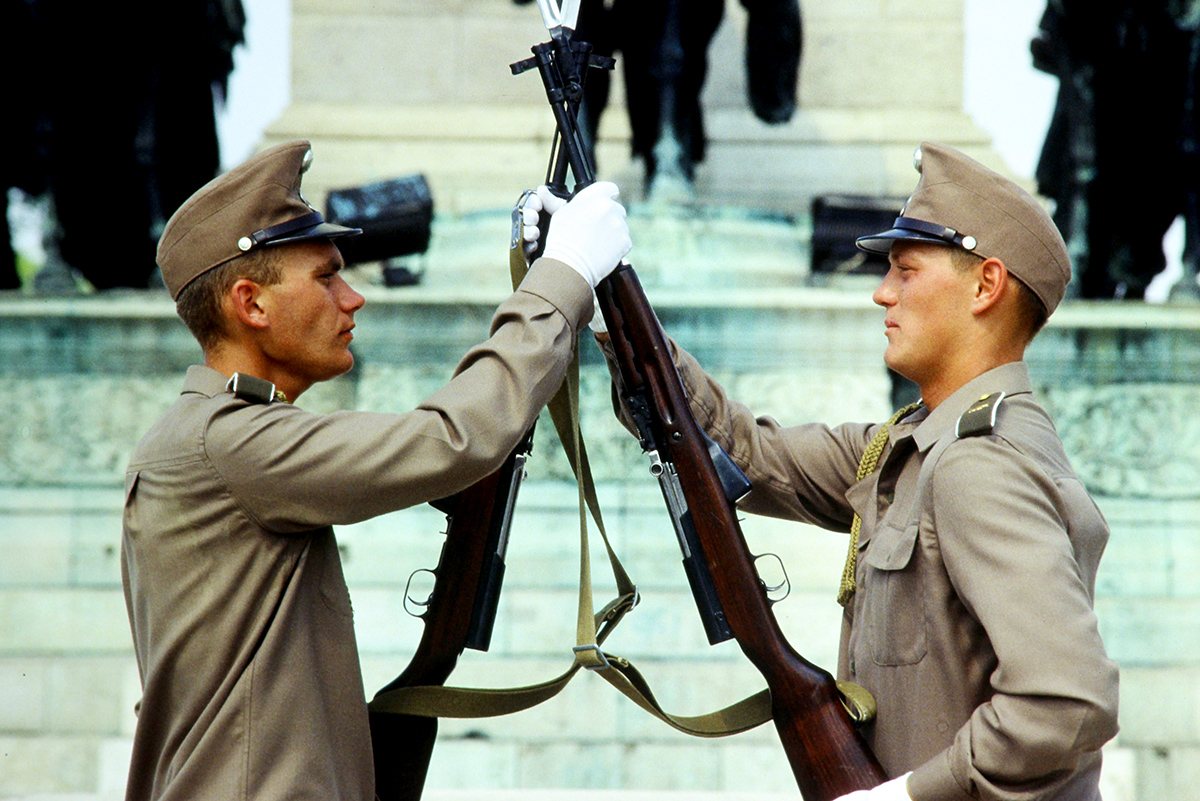Blast From The Past - Summer 1994 - This shot of Guards at Heroes Square in Budapest, Hungary, was taken on one of my trips taken there during Operation Deny Flight, which was a North Atlantic Treaty Organization (NATO) operation that began on 12 April 1993 as the enforcement of a United Nations (UN) no-fly zone over Bosnia and Herzegovina. 

According to Wikipedia: Heroes Square is one of the major squares in Budapest, Hungary, noted for its iconic statue complex featuring the Seven chieftains of the Magyars and other important Hungarian national leaders, as well as the Memorial Stone of Heroes, often erroneously referred as the Tomb of the Unknown Soldier. 

The square lies at the outbound end of Andrássy Avenue next to City Park (Városliget). It hosts the Museum of Fine Arts and the Műcsarnok. The square has played an important part in contemporary Hungarian history and has been a host to many political events, such as the reburial of Imre Nagy in 1989.