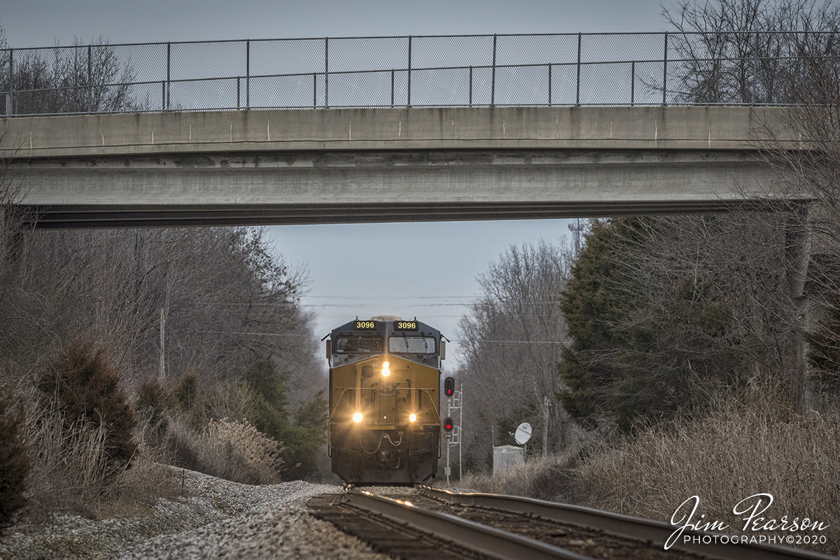 January 9, 2020 - CSXT 3096 leads loaded coal train N307 as it passes the signals at the RR location known as poorhouse, as it heads south on the Henderson Subdivision at Madisonville, Ky.

This location got it's name from the L&N Railroad days when the Hopkins County Poorhouse stood near here.

According to the Kentucky Historic Institutions website: In 1910 there were more than 84 thousand paupers that were enumerated in poorhouses in the United States; this was a marked increase of 3 percent compared to 1904. In Kentucky, the number of enumerated people in poorhouses in 1910 were 1,522; 871 being male and 651 being female. Of that population, 1,044 were native born, 167 were foreign born, 27 have unknown nativity, and 284 were colored. Irish and Swiss immigrants had a much high ratio of pauperism in 1910 than any other nationality. 

According to the occupations of individuals admitted into poorhouses, unskilled laborers made up the highest number. Skilled trades also held a relatively considerable number as well. Women frequently were domestic servants prior to admission. A relatively large number of about two filths reported being unable to do any work of any kind. A statistically significant number of paupers during the year 1910 were consider physically or mentally defective though the number of insane and feeble-minded almshouses was on the decline in 1910. Three fourths of discharges were done so as self-supporting. Approximately 17,000 paupers died in poorhouses during 1910 a rate of 207.7 paupers per 1,000. The most common cause of death at that time was tuberculosis of the lungs.

In earlier days, poorhouses were sometimes used as temporary shelters for vagrants as well as a place of detention for petty criminals. This was often due to poorhouses being the only public agency available to offer relief, even to those who were insane, feeble-minded, or epileptic. Some communities combined poorhouses with free hospitals or infirmaries that catered to the poor.