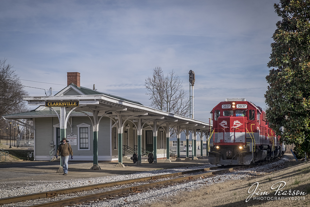 December 20, 2019 - RJ Corman's Cumberland City local passes the old L&N Railroad Station at Clarksville, Tennessee as it heads south on the Memphis Line with RJC 3837 and 3801 leading as it heads to Cumberland City to do its work for the day.

According to Wikipedia: The L & N Train Station is a restored railroad station in Clarksville, Tennessee. It was opened by the Memphis, Clarksville and Louisville Railroad in 1859.

It was restored in 1996 to circa 1901 AD condition and includes a diesel locomotive and caboose donated by RJ Corman railroad. It is currently home to the local farmers market and a local art society. It can also be rented out for events.

The station was at first widely believed to be the one referenced in The Monkees 1966 song "Last Train to Clarksville", though this turned out to be just a coincidence.