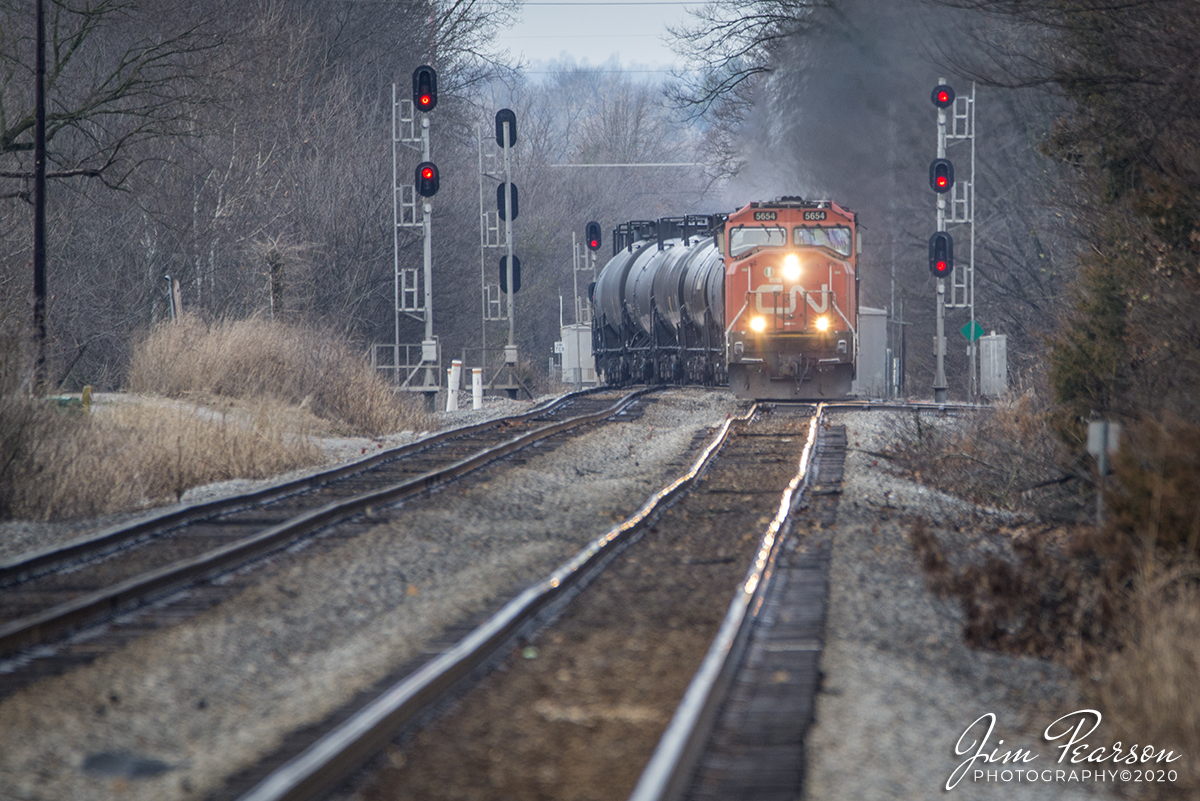 January 18, 2020 - Canadian National 5654 as it leads the way on CSX K445 nosing it's way over onto main 1 at the north end of Pembroke at Hopkinsville, Ky, with my 600mm, as it heads south on the Henderson Subdivision with a heavy ethanol train.