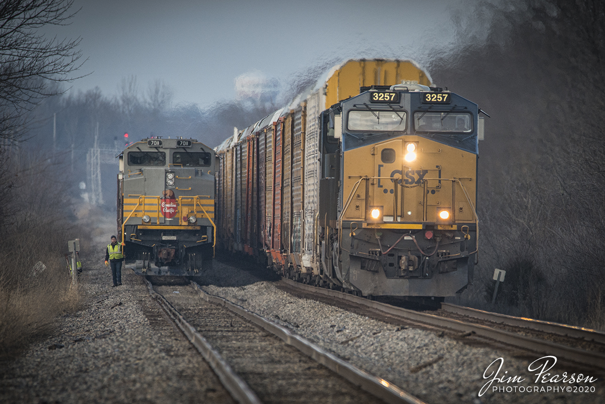 January 26, 2020 - The Crew on CSX K815 (empty phosphate train) keeps a watchful eye, next to Canadian Pacific Heritage Unit 7011, as CSX autorack train Q217 passes it at Middle King south of Princeton, Indiana as it heads south on CSX's CE&D Subdivision. 

Canadian Pacific Railway No. 7011, is one of several recently released SD70ACu (Rebuilt by Progress Rail in Mayfield, Ky) units delivered in heritage paint with script lettering.

I along with 11 other railfans stood at the crossing on County Road 550 waiting for K815 to continue it's move south, but after 6+ hours sitting in the siding watching other trains pass, it unfortunately didn't continue it's move before it got dark. In fact, last word we heard from the scanner was that the Danville, IL crew was waiting for a crew bus to take them off their train and that another K-train would hook into K815 and take it on to Evansville, Indiana.

Don't know what the issue with the train was, but there was a lot of speculation and rumors of course, ranging from low priority to engine problems. Some days things just happen! I'm thankful for my 150-600mm lens which allowed me this shot from the road crossing as the train was probably 1/3 of a mile away. This shot was made @ 600mm on my full frame camera and then cropped in Adobe RAW.