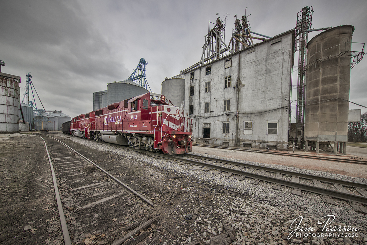 January 30, 2020 - Indiana Railroad (INRD) 3803 and 3806 power Palestine Utility train 1 (PAUT-1), as it passes through Mont Eagle Mills granary at Palestine, Illinois, on it's way north back to INRD's Palestine Yard, after doing its work at the Marathon Refinery in Robinson, Illinois on the INRD Indianapolis Subdivision. 

According to Wikipedia: The Indiana Rail Road (reporting mark INRD) is a United States Class II railroad, originally operating over former Illinois Central Railroad trackage from Newton, Illinois, to Indianapolis, Indiana, a distance of 155 miles (249 km). 

This line, now known as the Indiana Rail Road's Indianapolis Subdivision, comprises most of the former IC line from Indianapolis to Effingham, Illinois; Illinois Central successor Canadian National Railway retains the portion from Newton to Effingham. INRD also owns a former Milwaukee Road line from Terre Haute, Indiana, to Burns City, Indiana (site of the Crane Naval Surface Warfare Center), with trackage rights extending to Chicago, Illinois. 

INRD serves Louisville, Kentucky, and the Port of Indiana on the Ohio River at Jeffersonville, Indiana, through a haulage agreement with the Louisville & Indiana Railroad (LIRC).
