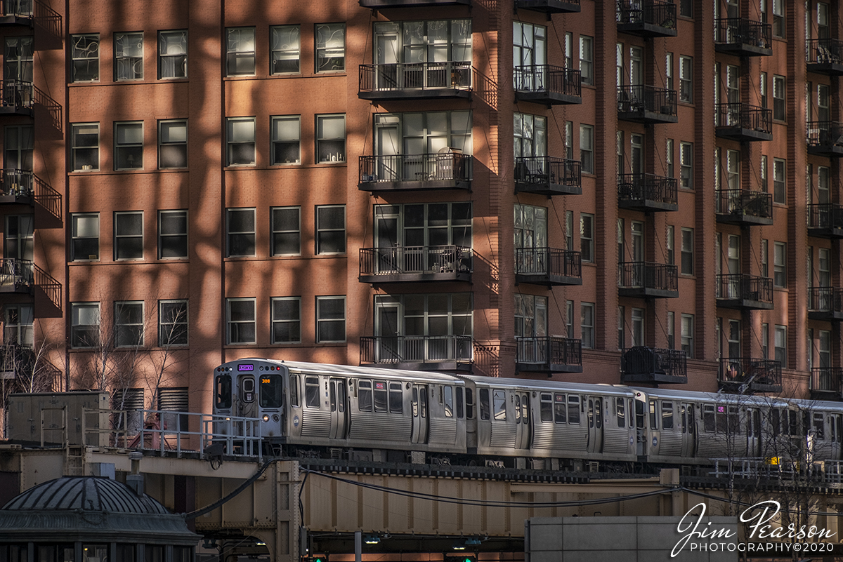 February 20, 2020 - Chicago Transit Authority Pink Line train 308 heads toward the loop in downtown Chicago, Illinois as the late afternoon light plays on the building behind it.