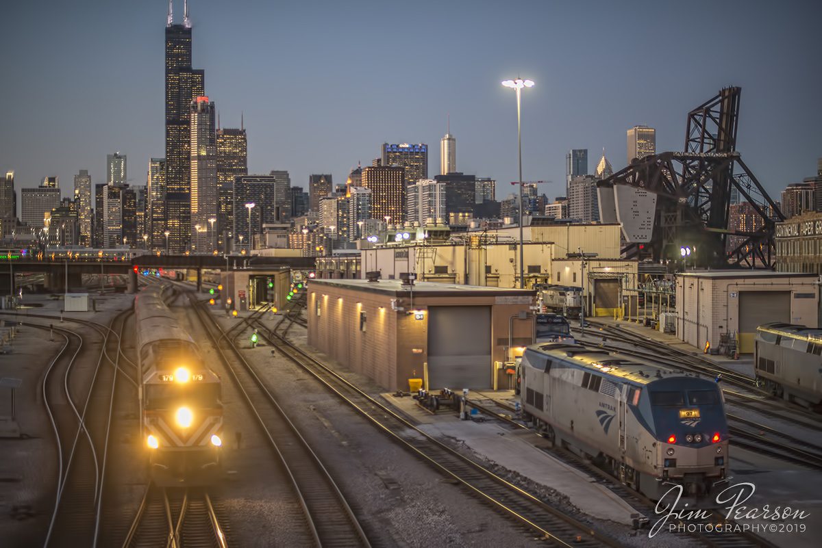 February 20, 2020 - Metra 179 pulls train #919 southbound commuter train out of downtown Chicago, Illinois past the Amtrak facility as it approaches the 18th street overpass, as dusk falls over the city, on its way to Joliet, Illinois on the Metra Heritage Corridor.