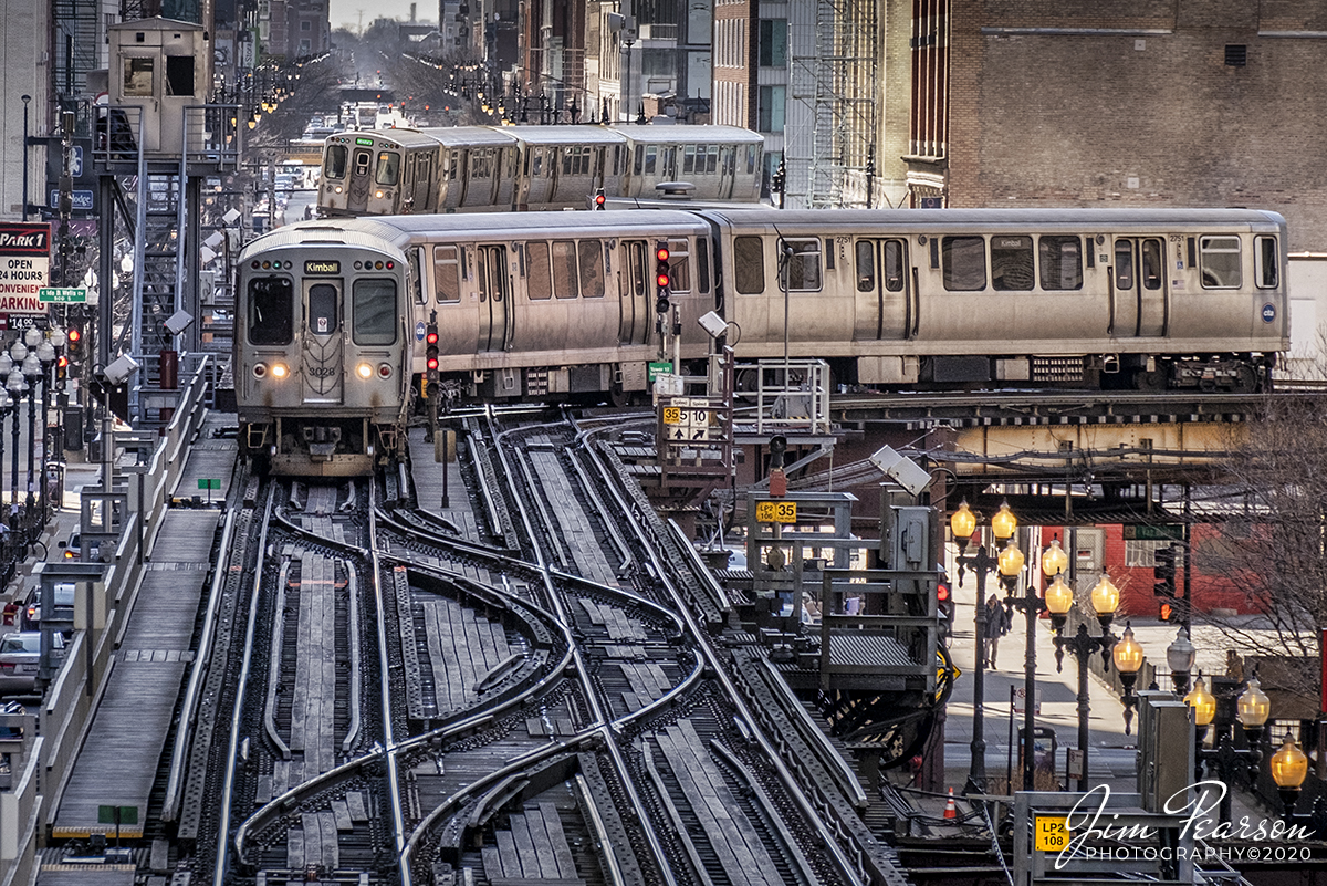 February 20, 2020 - A Chicago Transit Authority Brown Line and Green Line trains round curves at Tower 12 as they make their way around the downtown Chicago, Illinois "L". The first "L" (elevated) train (then Chicago and South Side Rapid Transit Railroad) was built in 1892, and its inaugural journey took place on June 6, spanning 3.6 miles in 14 minutes.