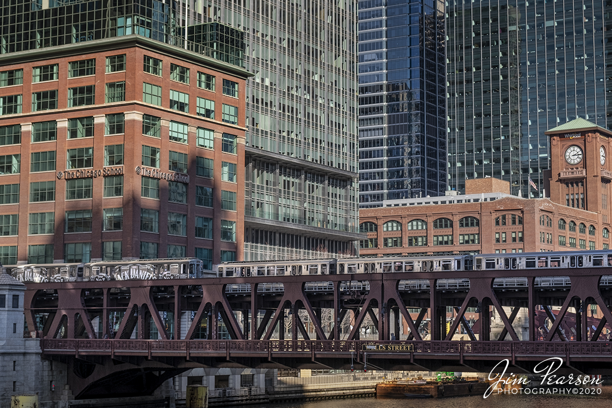 February 20, 2020 - Two Chicago Transit Authority commuter trains pass each other on the Wells Street bridge over the Chicago River as they make their ways through downtown Chicago, Illinois.