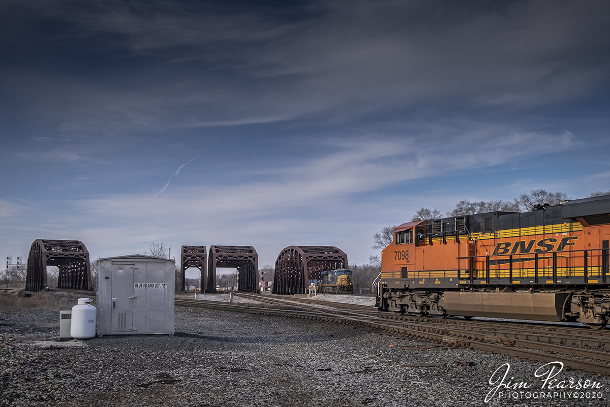February 22, 2020 - BNSF 7098 leads an west bound autorack train through Blue Island Junction on the Indiana Harbor Belt line at Blue Island, Illinois as a CSX Intermodal heads east on the Joliet Subdivision District.