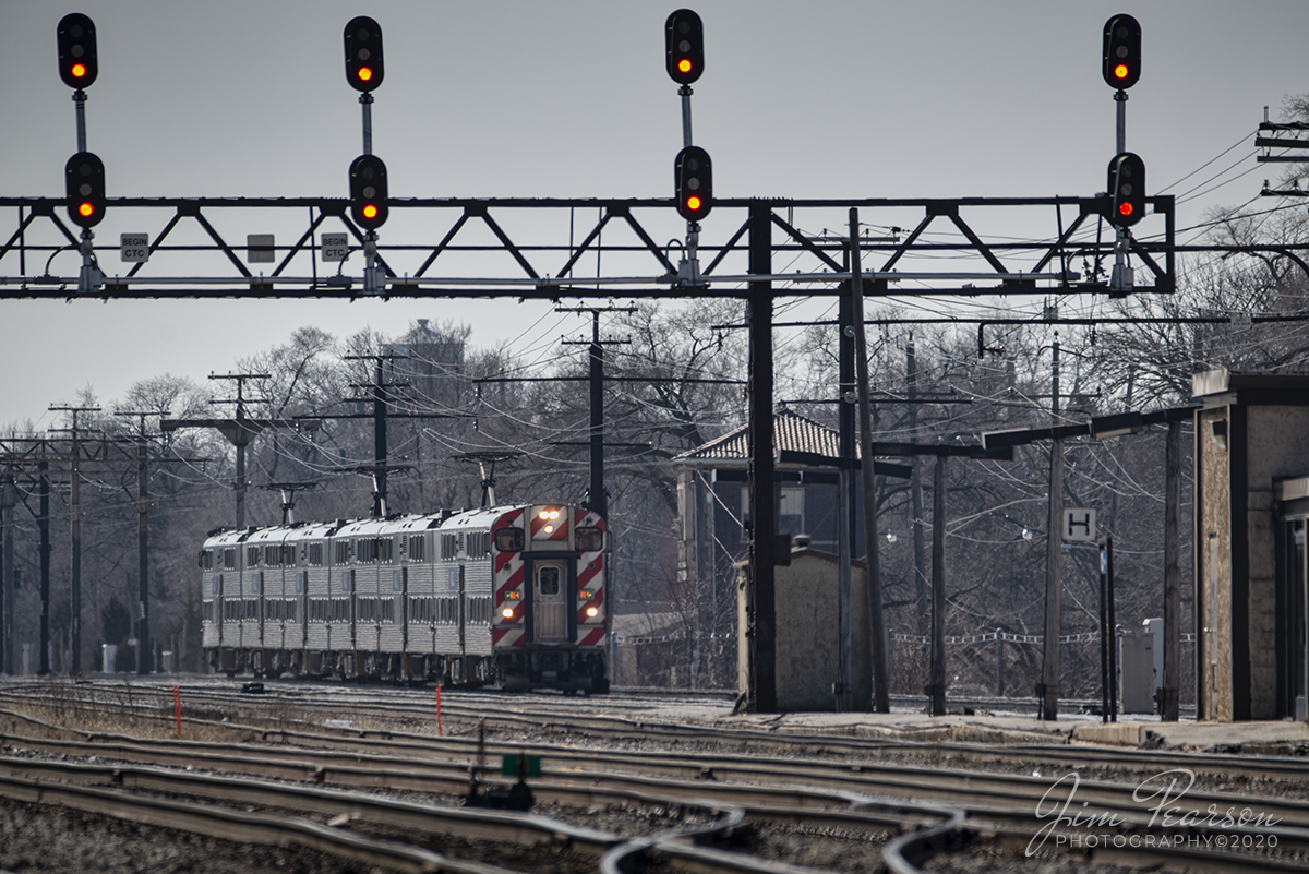February 22, 2020 -  Metra 184 arrives at the station in Homewood, Illinois as it passes the old IC/CN control tower on its run along the University Park Subdivision District to Chicago, Illinois.