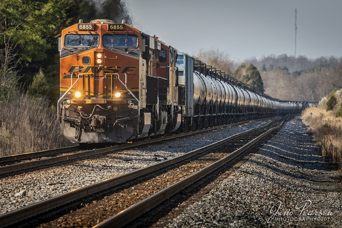 March 25, 2020 - Looking like a long centipede with all its tanks, BNSF 6855 leads CSX K423-24 as it makes its way along the main at the south end of Slaughters Siding, as it heads south on the Henderson Subdivision with a loaded ethanol train at Slaughters, Ky.