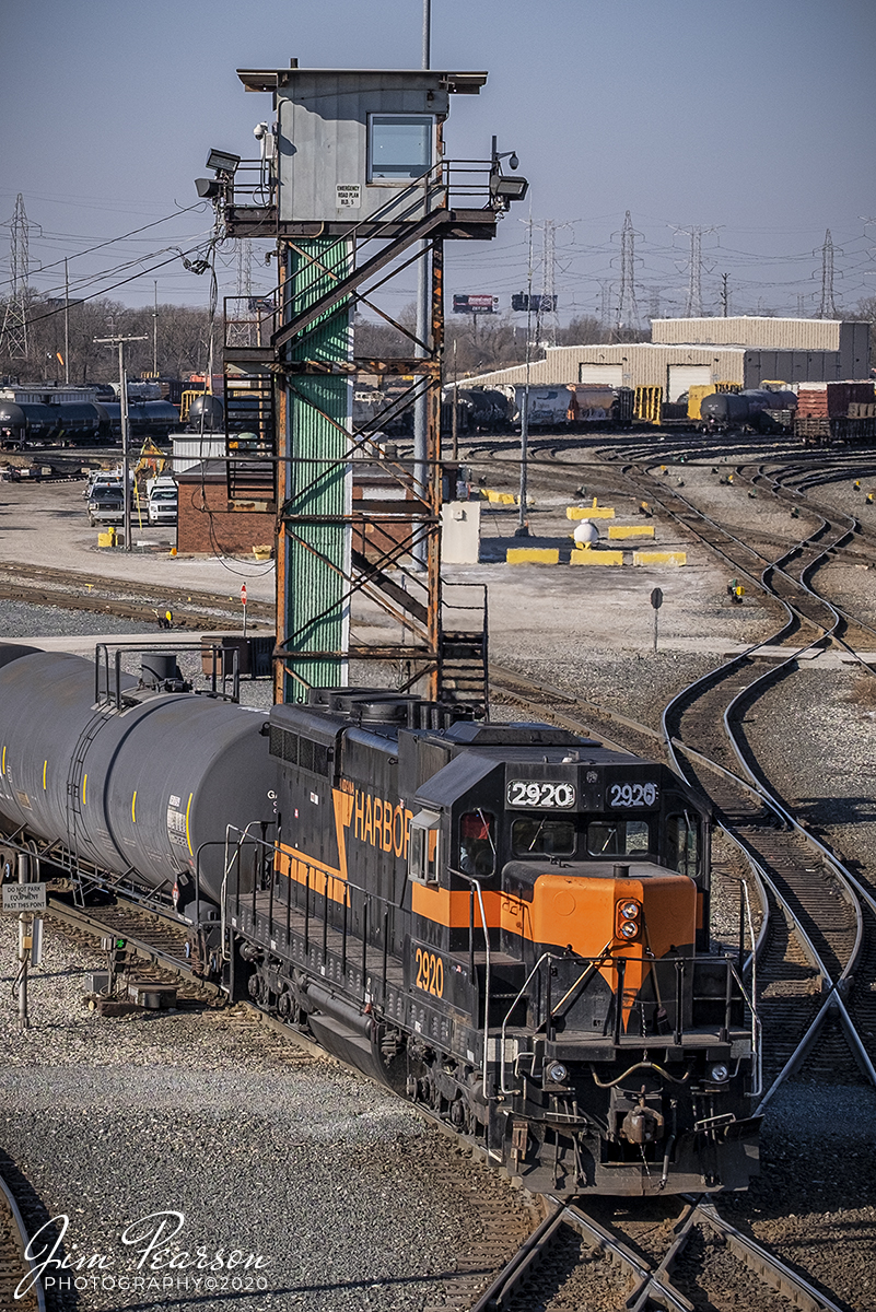 February 22, 2020 - Indiana Harbor Belt (IHB) 2920 (SD20 backs into the Blue Island Rail Yard at Riverdale, Illinois, past the old control tower, as it works on building a train. From what I find online the unit was built in 1959  and was rebuilt by Illinois Central in 1980 from IC 2010. Then it went to NRE in 2/95, and was leased to IHB 9/96, before being purchased by IHB 6/2007.

According to the IHB Website: The Indiana Harbor Belt Railroad is the largest switch carrier in the U.S. with 54 miles of mainline track (24 miles of which is double main track) and 266 miles of additional yard and siding track.

The IHB provides a wide variety of services, including industrial switching with 160 customers, generating 170,000 carloads of business annually. The IHB interchanges daily with 16 other rail carriers in Chicago. A growing fleet of approximately 1,400 freight cars is geared predominately to the steel industry. The industrial traffic base includes 4 of the 5 largest steel producers in the U.S. and a large aluminum processor, oil refineries, corn millers, grain elevators, chemical plants, warehouses, lumber transloading, and bulk transfer operations. IHB's industrial traffic consists of 38% primary metals, 12% chemicals & petroleum products, 11% food products, 8% scrap iron, 7% coal & coke, 6% whole grain, as well as a variety of other products including lumber, paper, and aggregates. The IHB also operates as an intermediate switch carrier between the 12 trunk-line railroads for traffic interchanged between them in Chicago, generating an additional 475,000 revenue cars.

The IHB main line circles Chicago from near O'Hare to Northwest Indiana and roughly parallels Interstate 294 (Tri-state Expressway) and I-80/94. Its primary yard, Blue Island (a 44 class track hump yard) at Riverdale, IL lies in about the center of the railroad. Other major yards includes Gibson (in Hammond, IN) which only classifies cars of new autos and Michigan Avenue Yard (in East Chicago) which serves the extensive steel plants which accounts for IHB's primary business. From East Chicago, the IHB operates east for an additional 16 miles on trackage rights to access Burns Harbor, IN and Portage, IN, which includes Indiana's International Port.