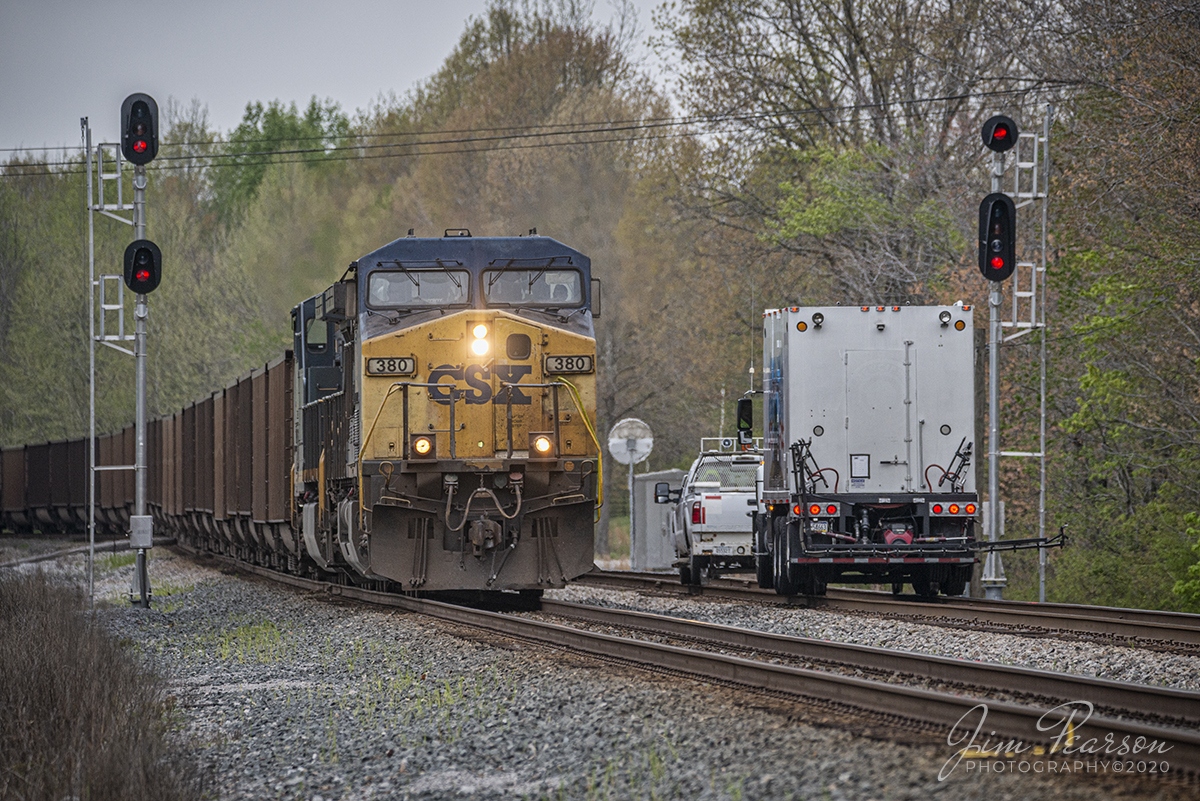 April 14, 2020 - CSXT 380 leads empty coal train E013-13 as it passes a weed sprayer crew at CP Romney as it heads north on the Henderson Subdivision at Mannington, Ky.
