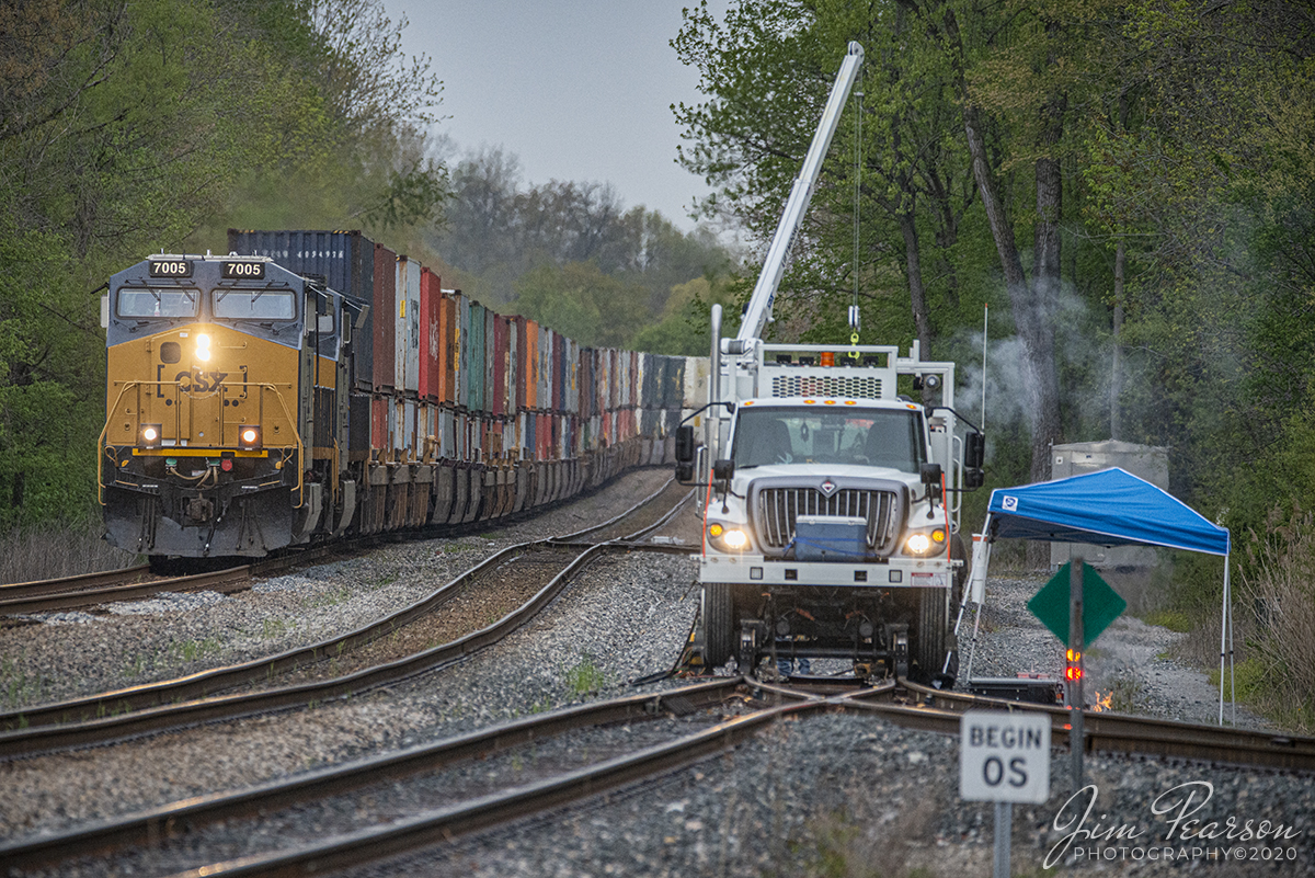 April 17, 2020 - CSXT 7005 leads Q025-17 past a crew working on a switch at Anaconda, south of Robards, Ky as it heads south on the Henderson Subdivision with a stack train.

In case you're wondering about the "Begin OS sign," from what I find on the web it is an old time term used by telegraph operators and train dispatchers to indicate that a train has passed a particular location on a subdivision. "OS" means "on sheet" referring to the fact that the train dispatcher has recorded train movement on the train sheet he maintained each 24 hour period. It also means Originating Station, the first station on each subdivision from which a train is authorized to occupy the main track.