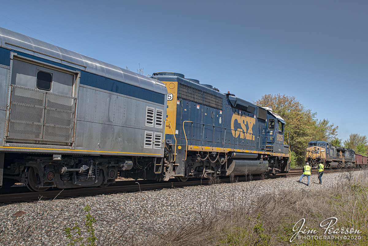 April 20, 2020 - The crew on CSX Geometry inspection train W001 conducts a roll-by inspection ballast train W086 at the north end of Robards Siding as it heads south on the Henderson Subdivision at Robards, Kentucky.